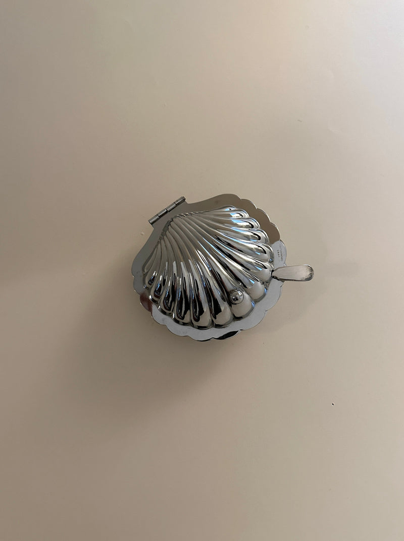 White butter dish in the shape of a seashell with a hinged lid