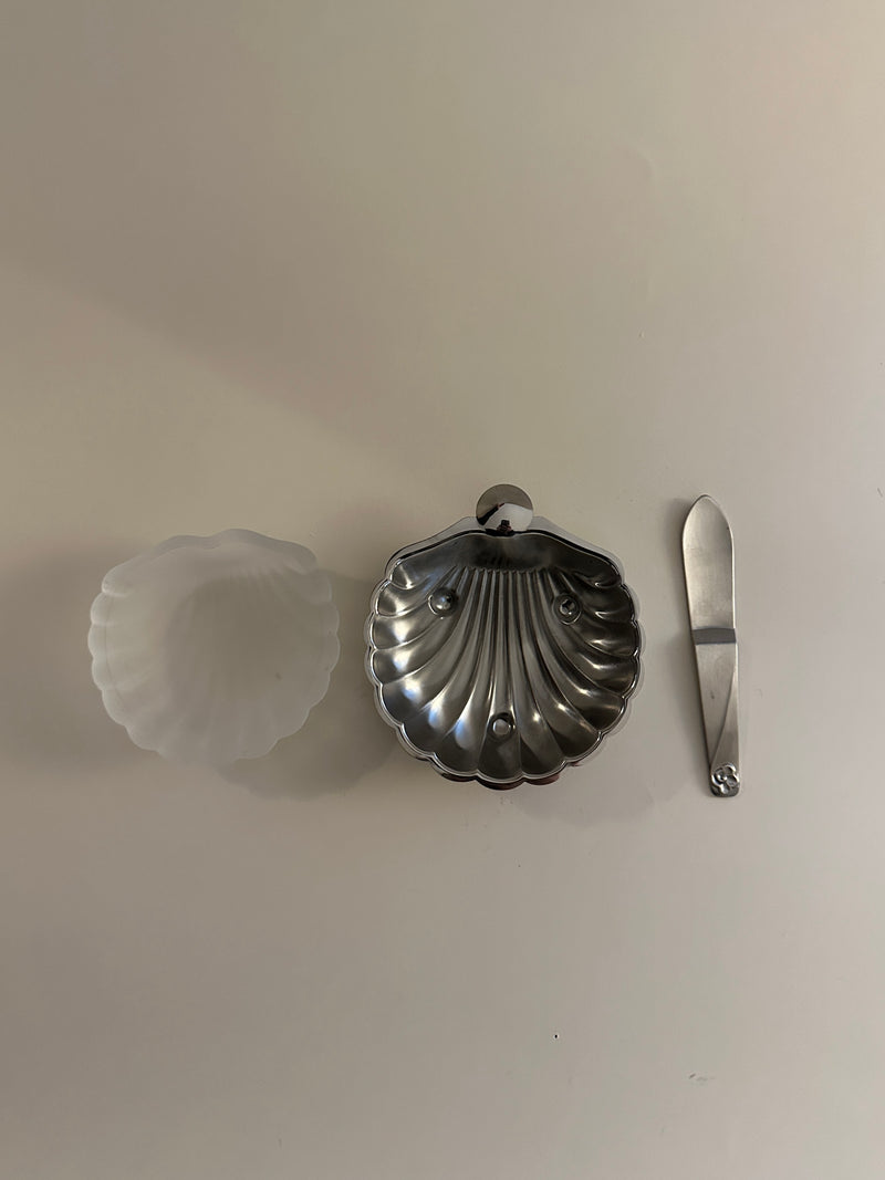 White ceramic butter dish with scalloped edges and matching lid