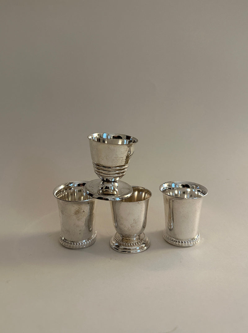 Shiny silver plated egg cups in a set of four, perfect for serving breakfast