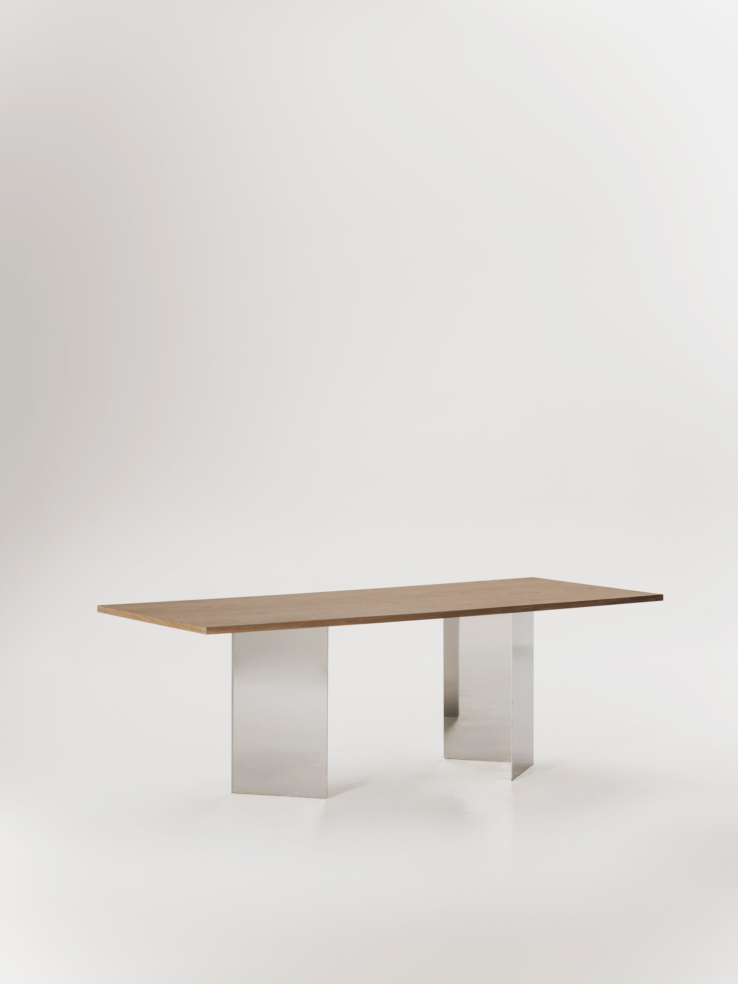 Ander dining table — back view highlighting stainless steel legs
