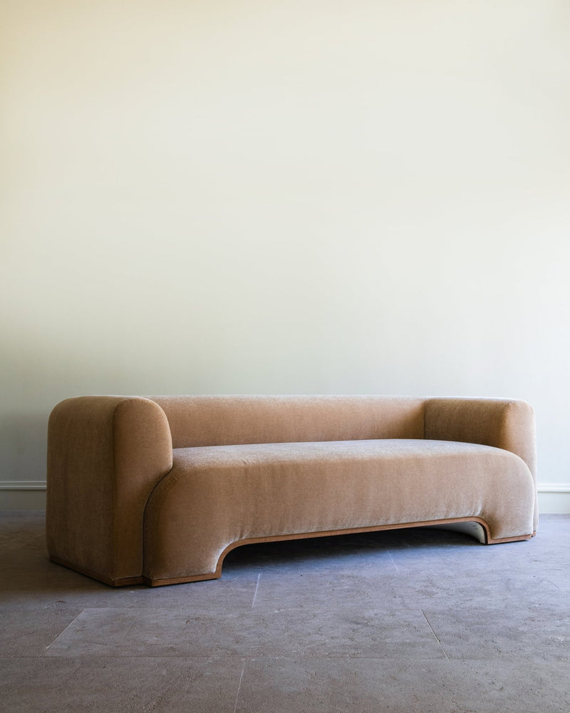 Curved beige Quincy sofa by Studio OSKLO with rounded edges