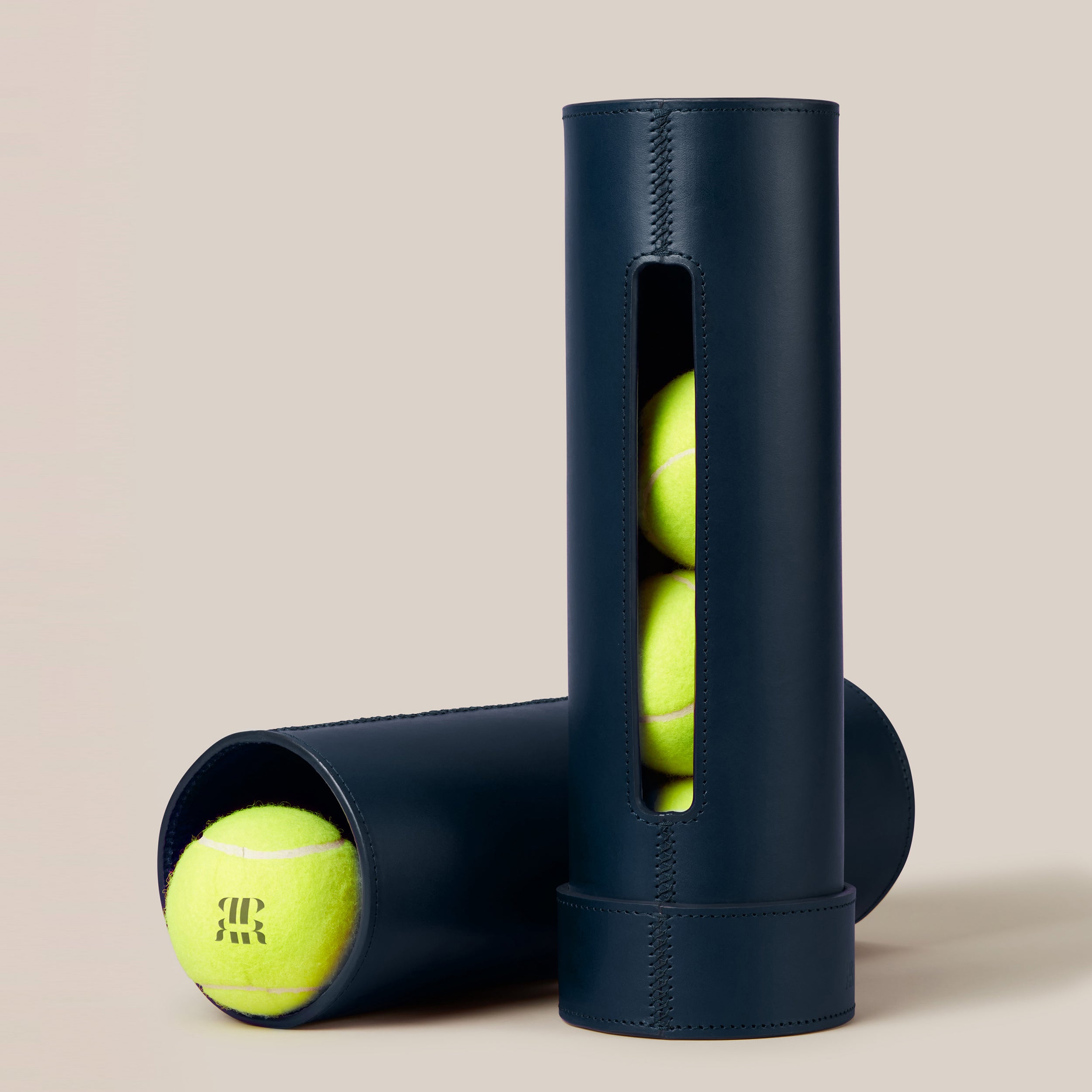 Leather Tennis Ball Holder — close-up of navy leather with tennis balls visible
