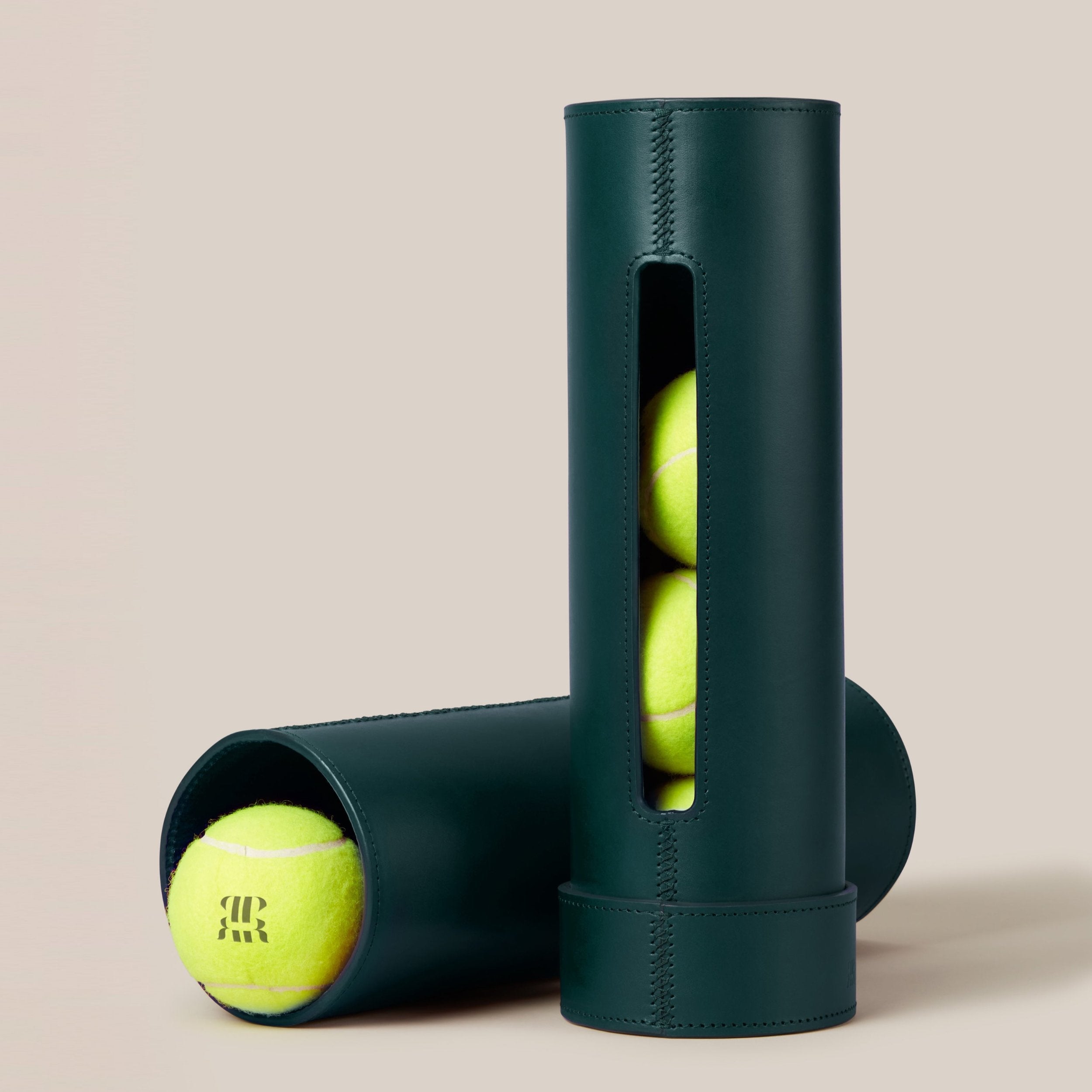Leather Tennis Ball Holder — angled view showing green leather with tennis balls inside