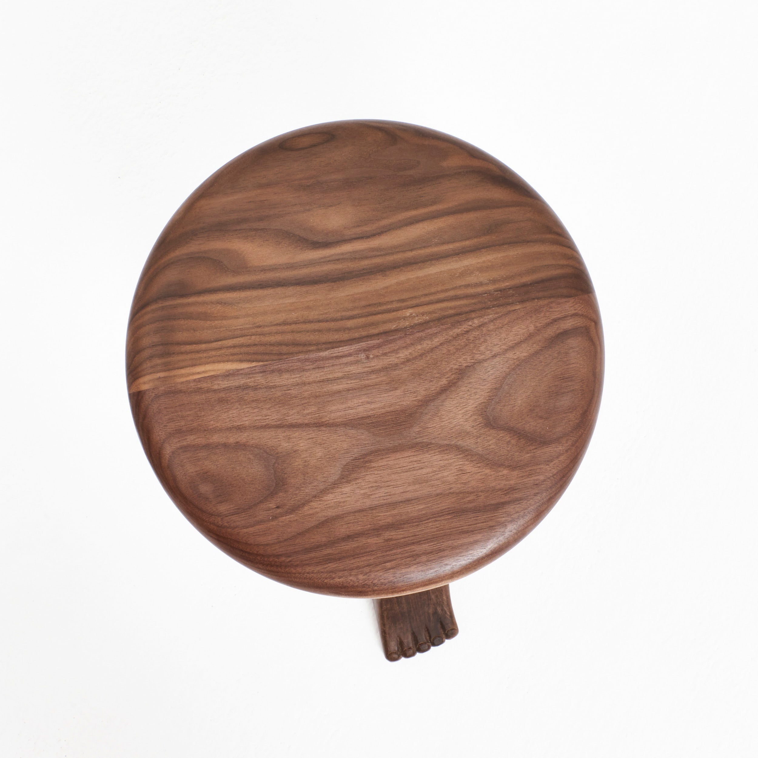 Foot Stool in Oak — top view of round wooden seat