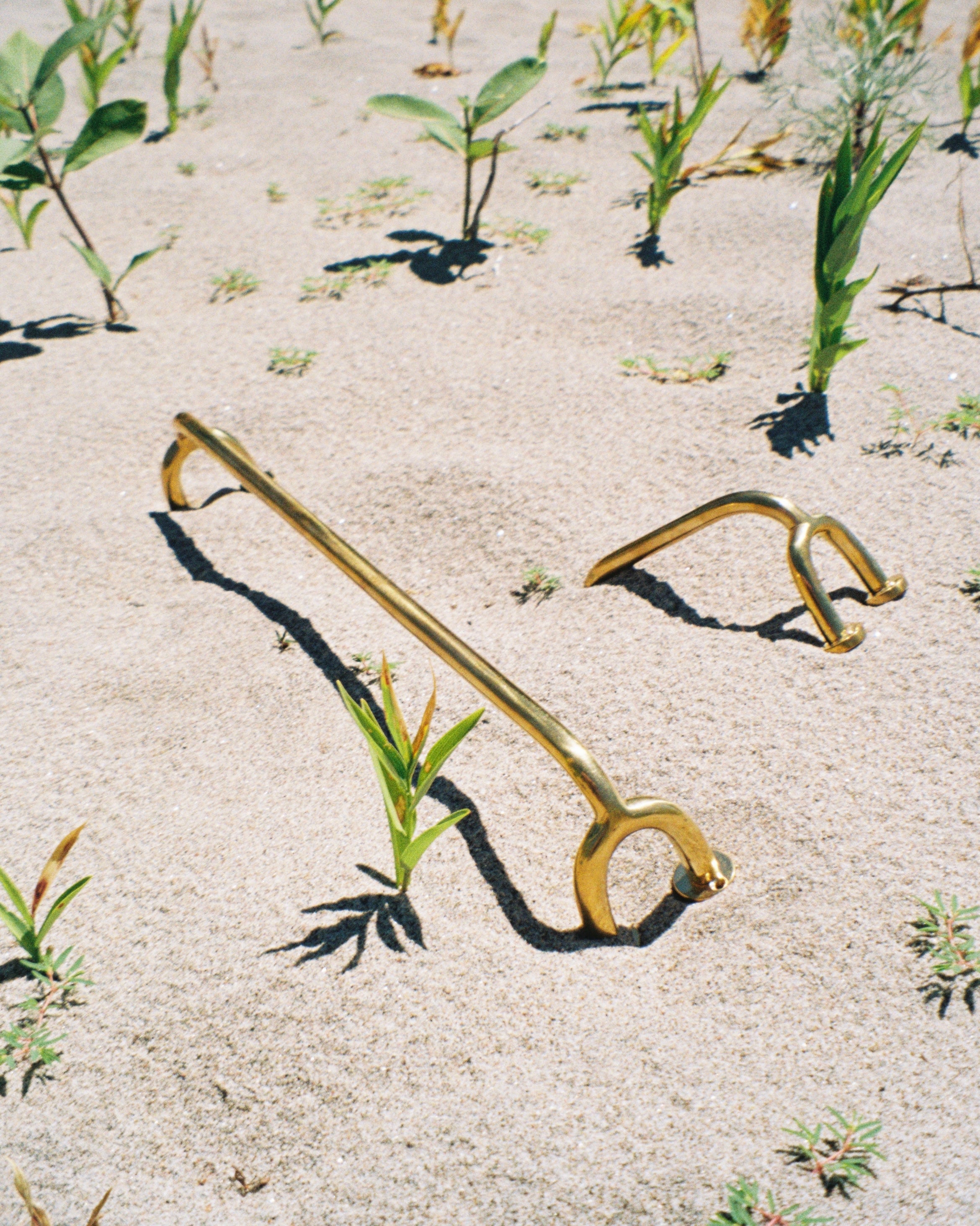 FAUNA Towel Bar (2 sizes) — gold finish on sandy outdoor setting