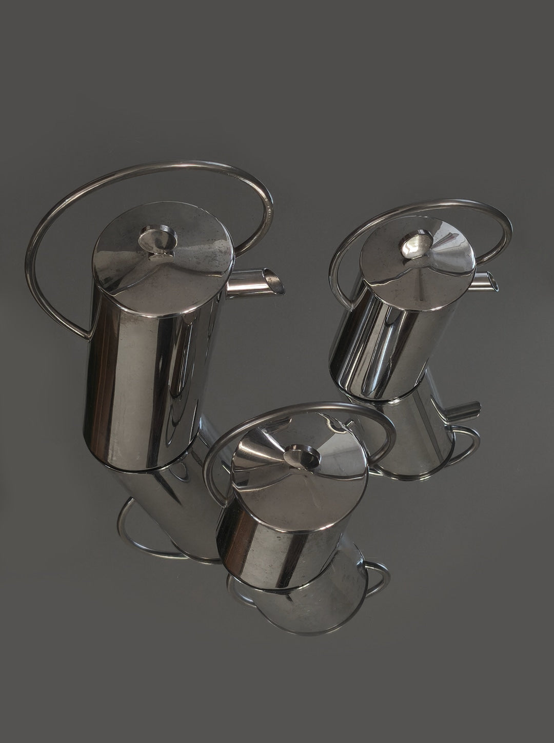 Reflective silver-plated Italian coffee set with three teapots