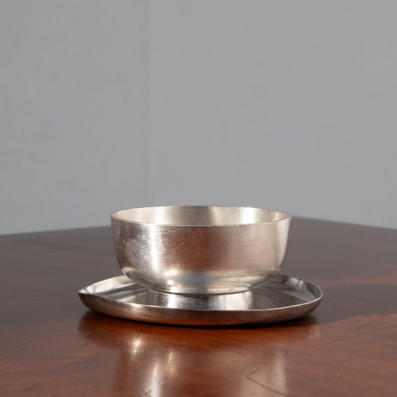 Metal Serving Bowl - Arthur Krupp — close-up of polished metal on wooden table