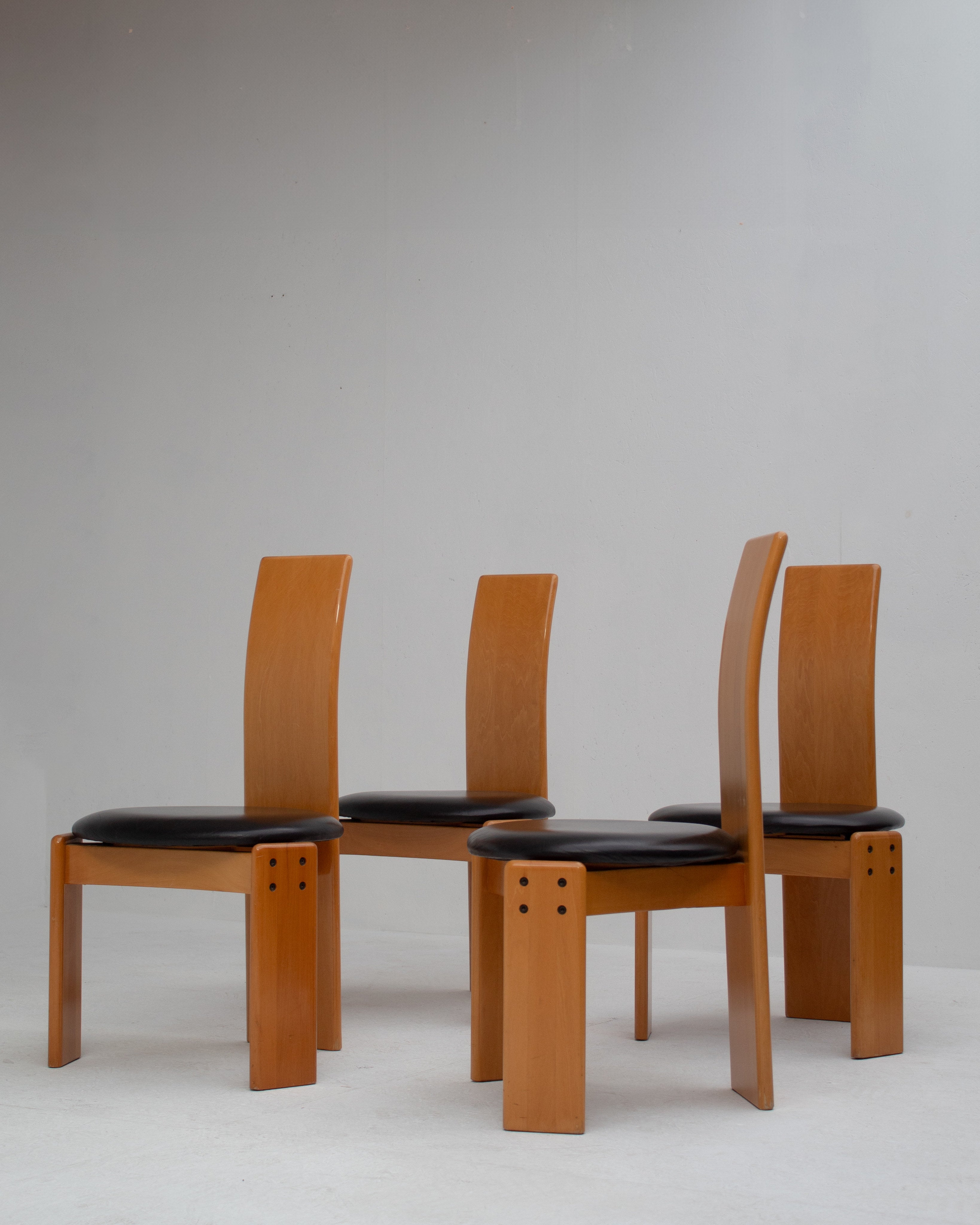 Set of Dining Chairs in Wood and Leather by Mario Marenco for Mobil Girgi — side angle showing wooden frames and black leathe