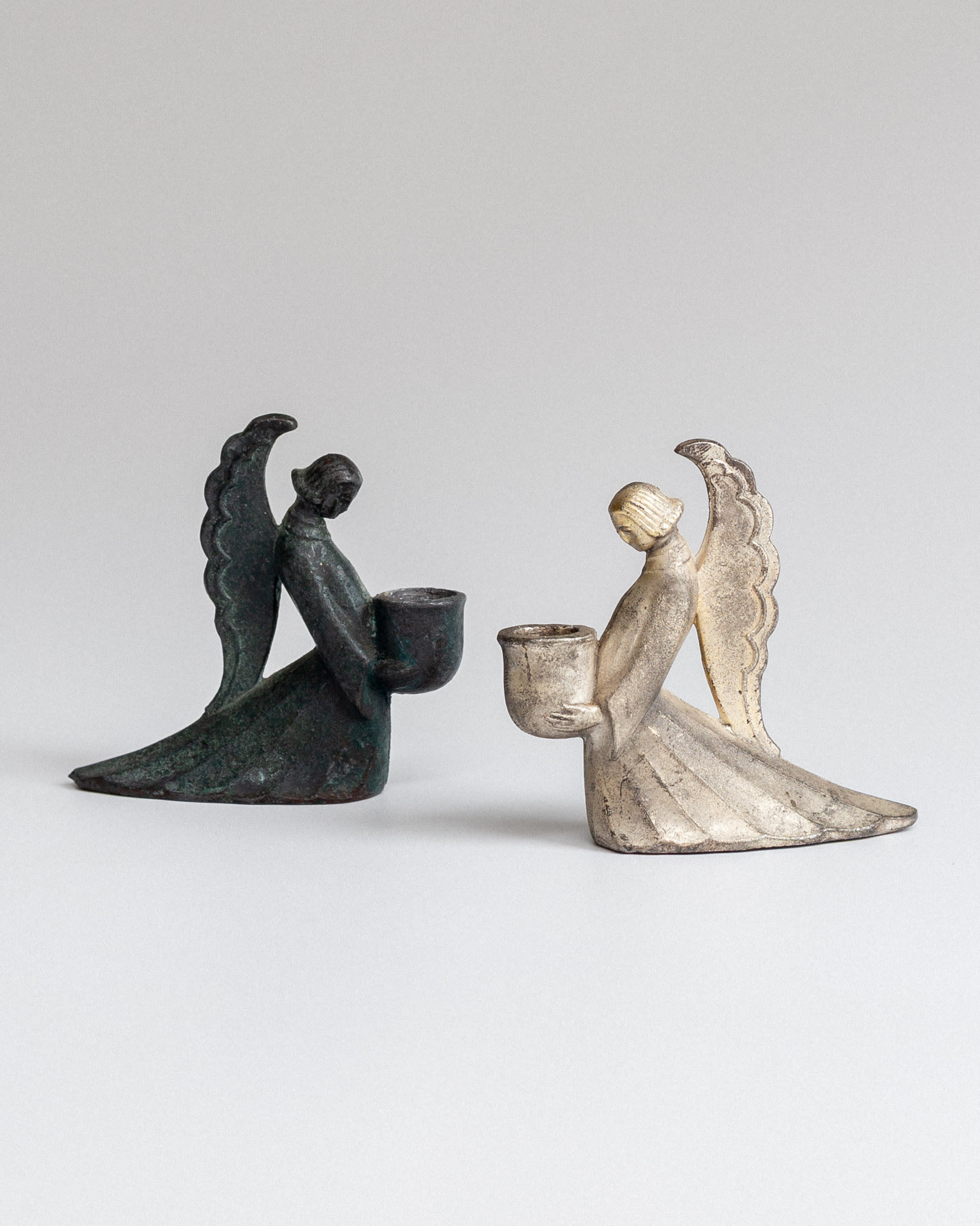 Set of Swedish Art Deco Figural Angel Candlesticks — angled view on neutral background