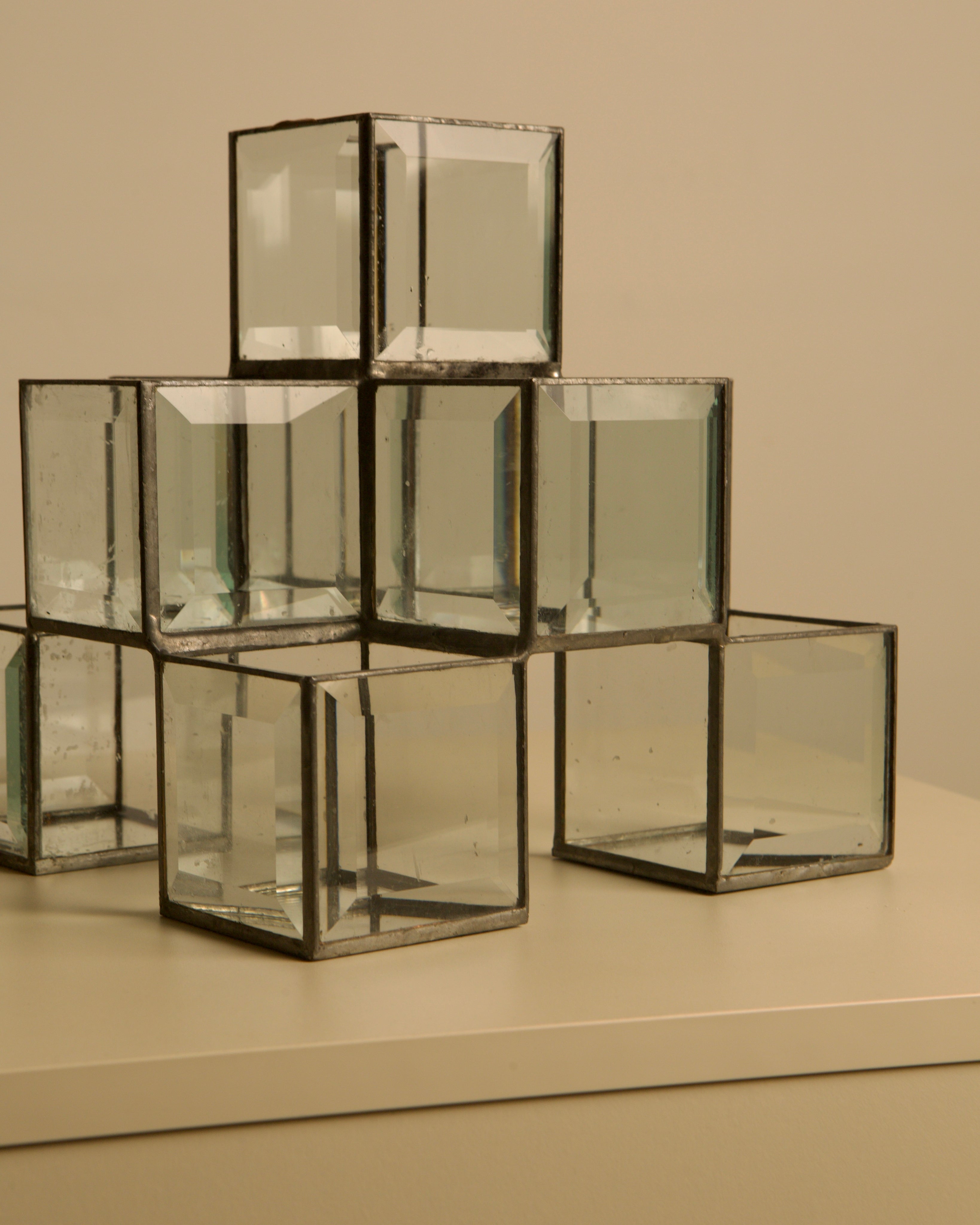 Italian handcrafted metal and glass candle holder from the 70s — angled view on neutral surface