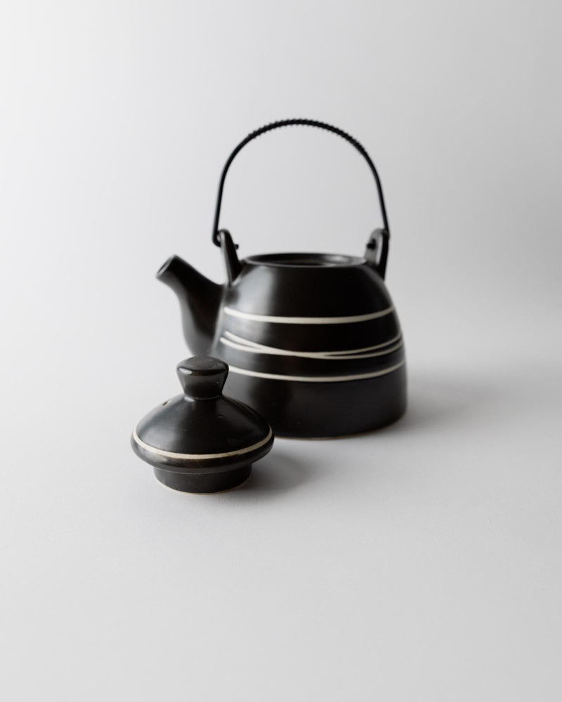 1980s Ceramic Teapot — close-up of black ceramic with white stripes