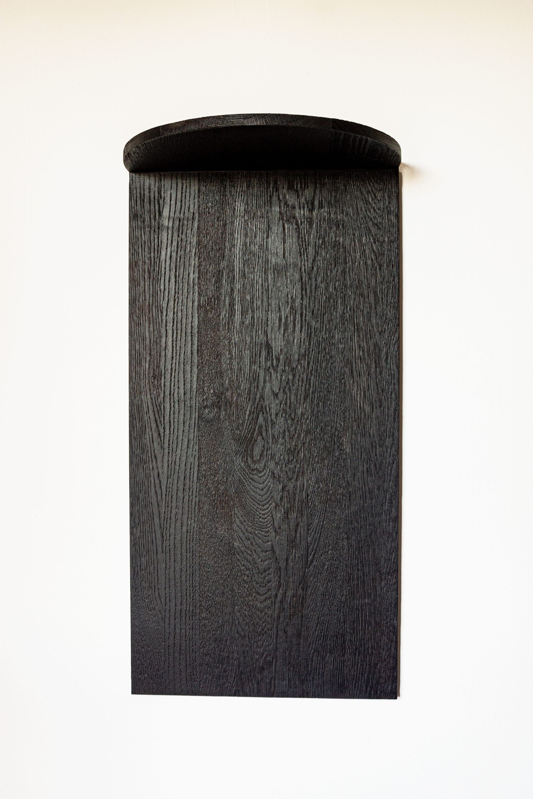 Cylindrical black oak shelf detail showing wood grain texture