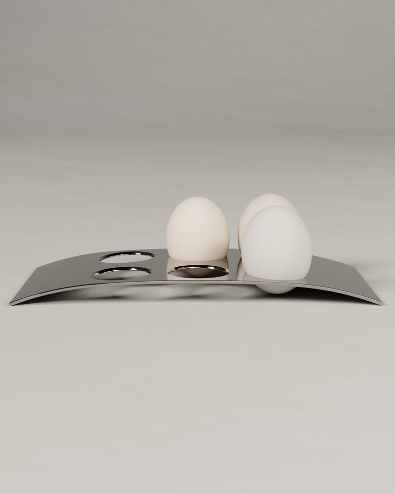 Modern curved stainless steel egg rack holding two white eggs