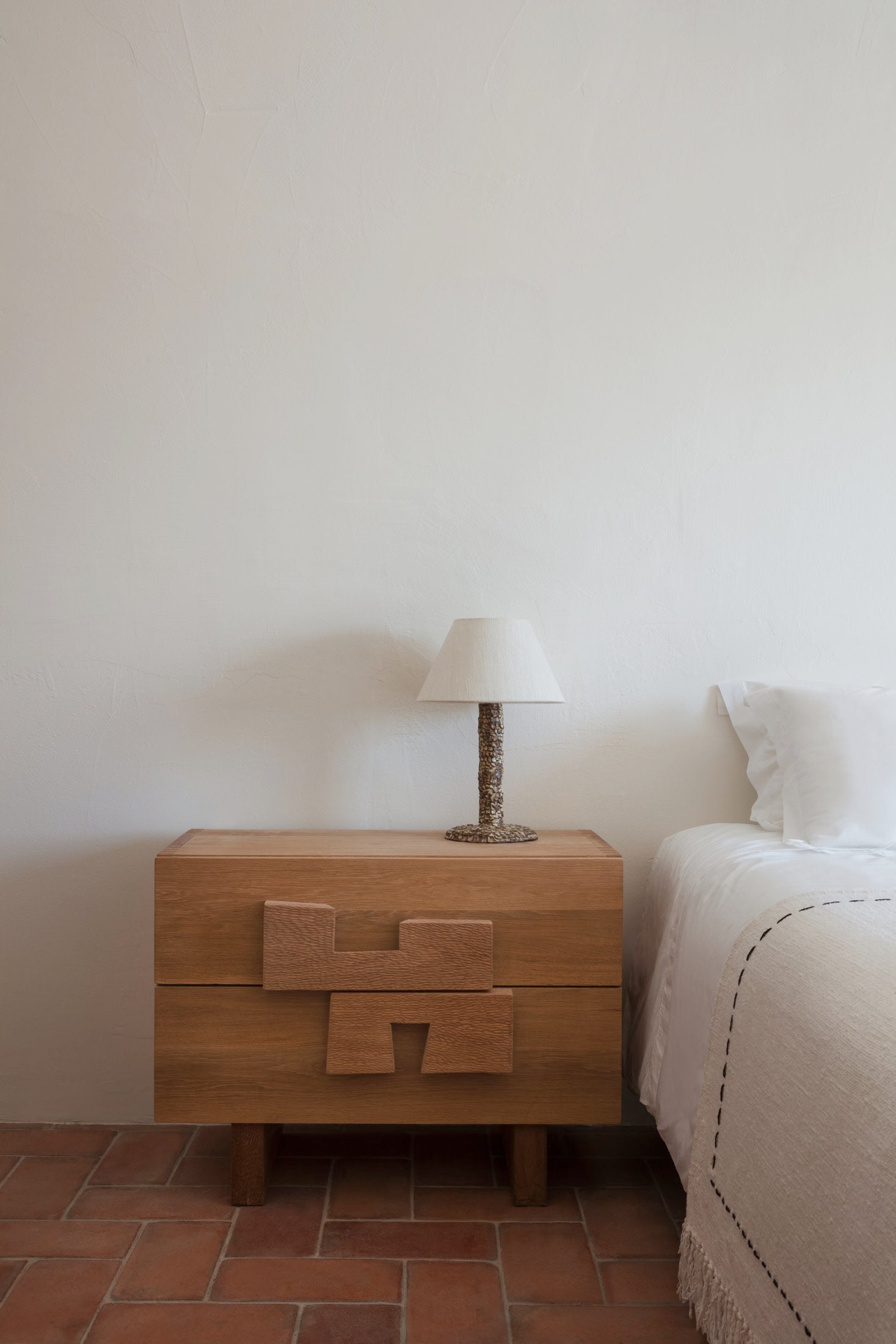 Casa Bedside Light — top view on wooden nightstand with textured lamp base