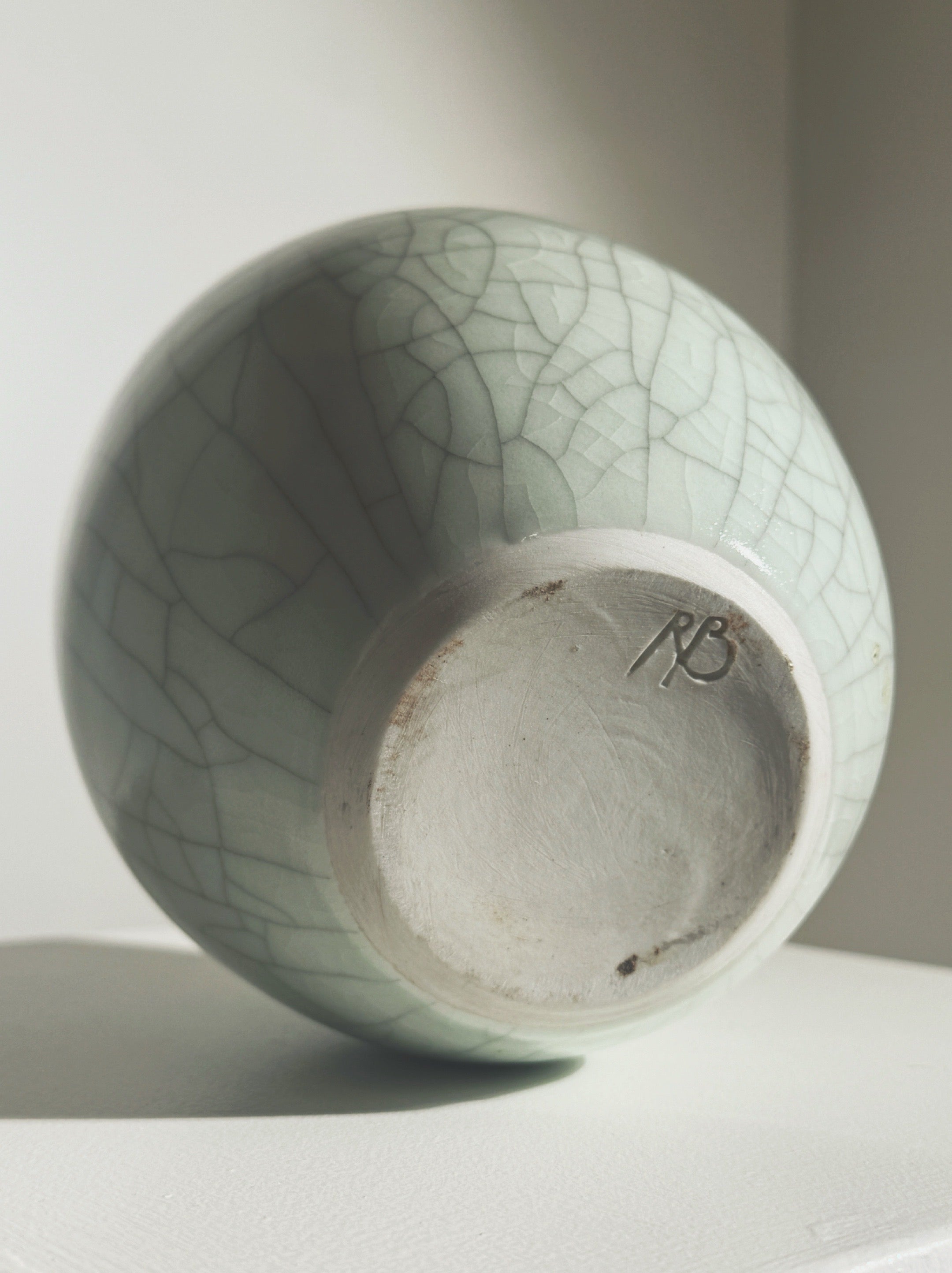 White ceramic vase base showing Roland Breton maker's mark detail