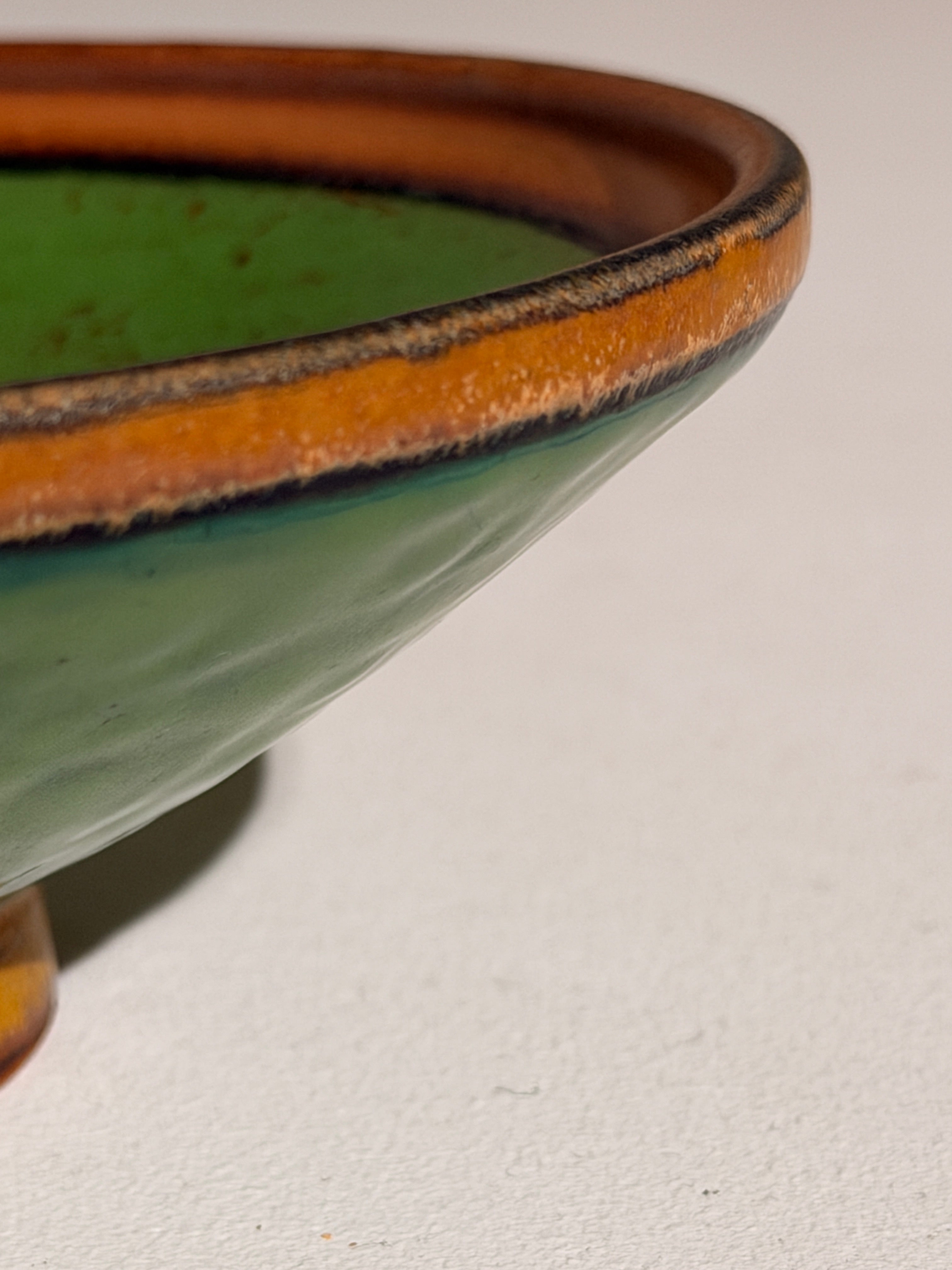 Ceramic Bowl by Louis Lorioux, France, circa 1930 — angled view highlighting green glaze and orange rim