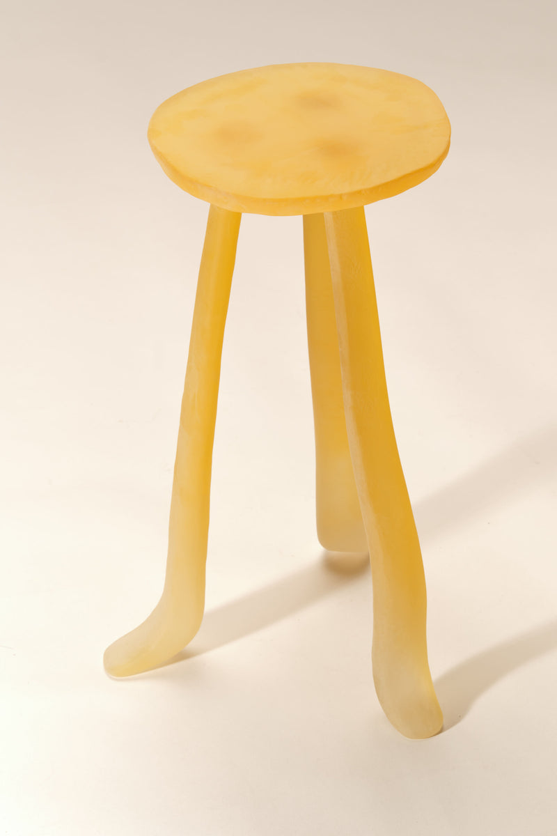 Honey-colored wooden side table with curved legs by Szymon Keller