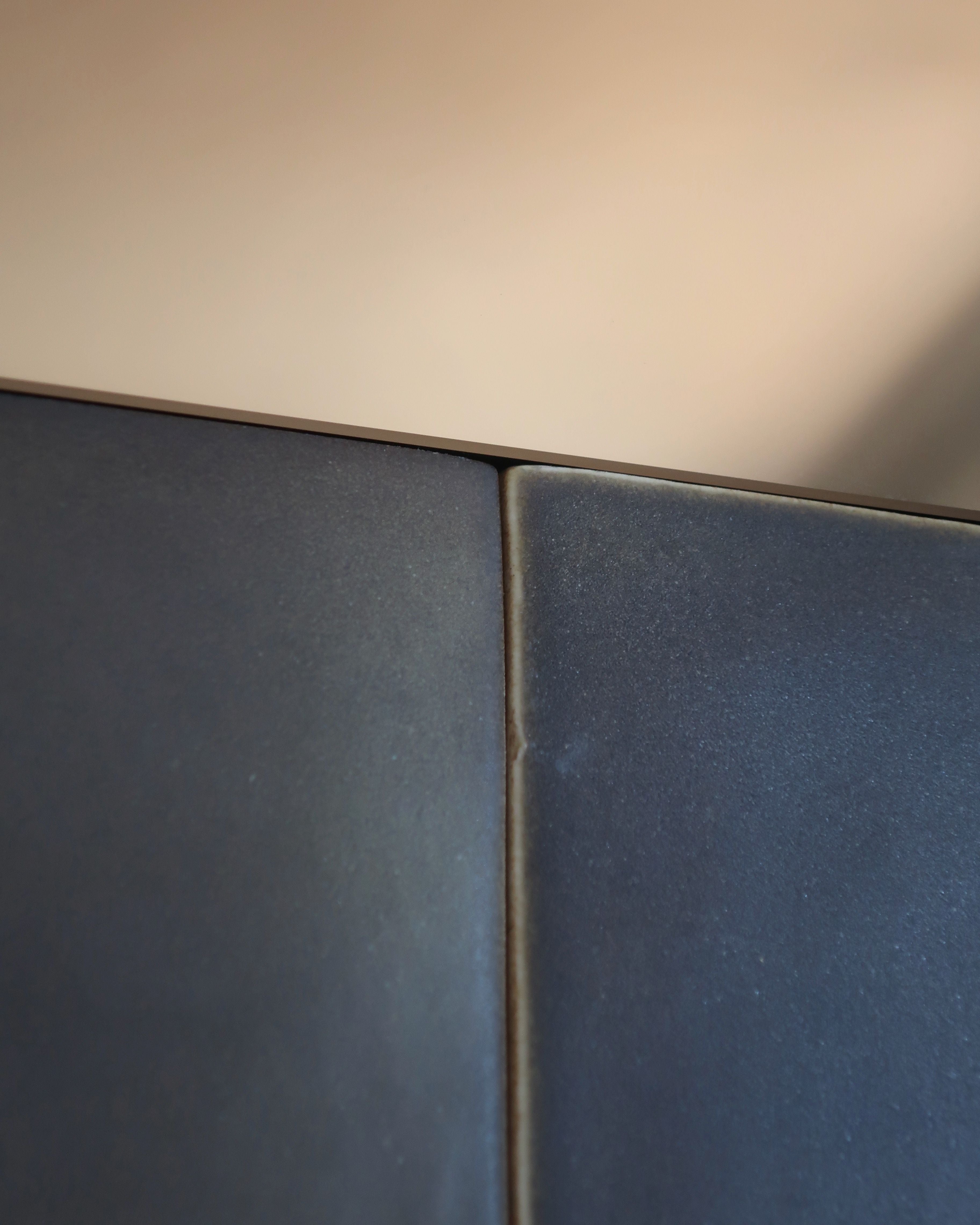 GIO I mirror detail showing blue geometric panels and brass trim