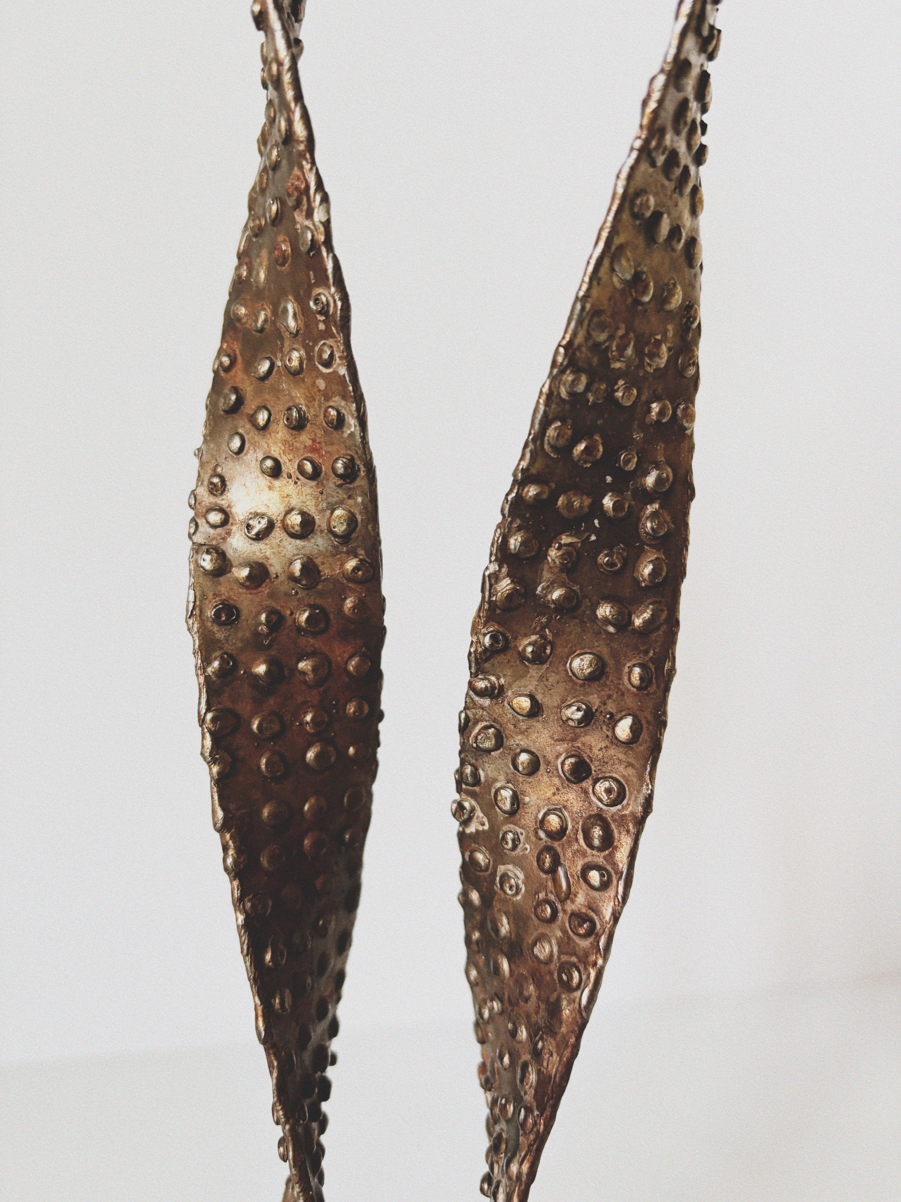 Textured Metal 2 Arm Candlestick, Poland — close-up of textured metal surface