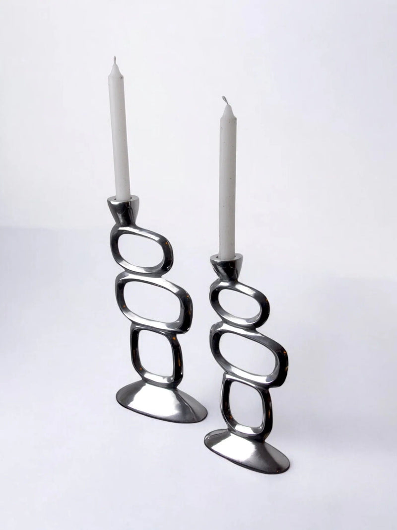 Pair of Candleholders by Matthew Hilton, 1980 — close-up of polished metal surface