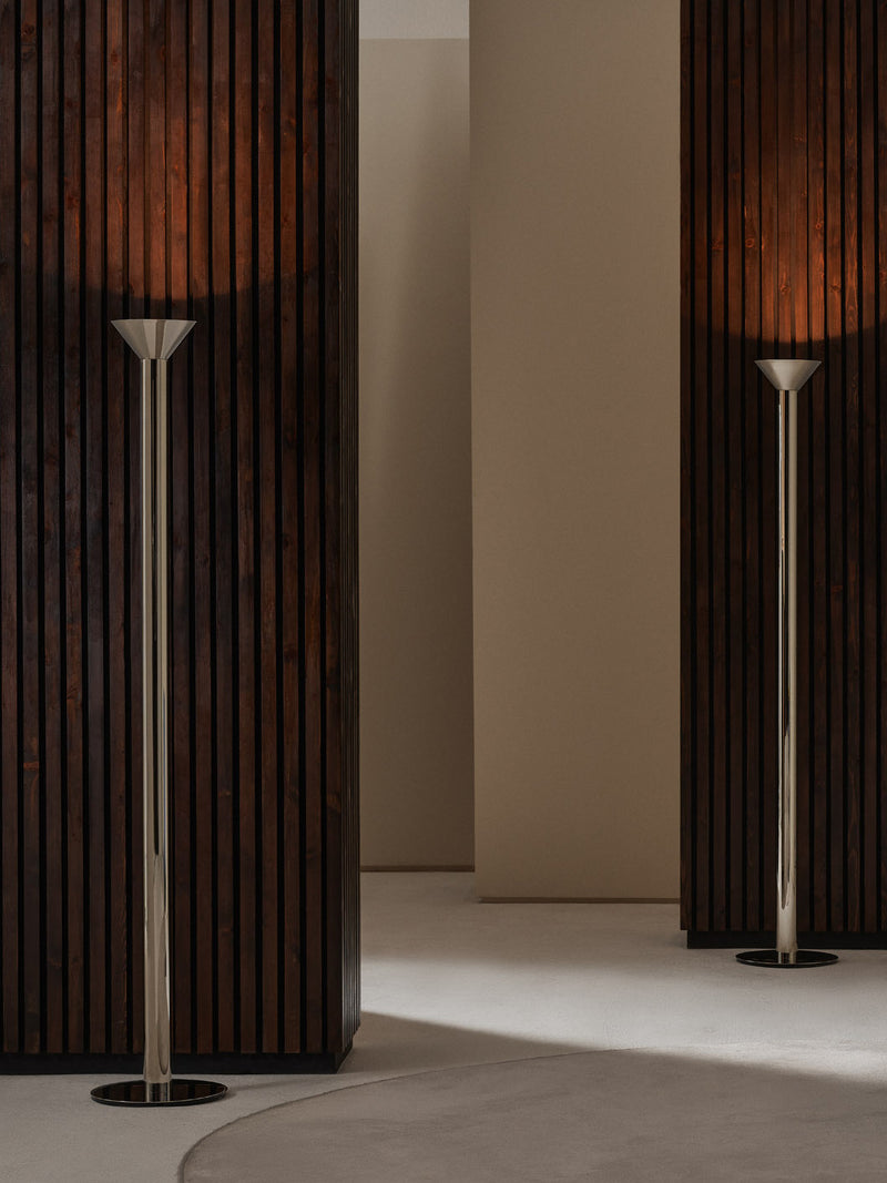 TORRES Uplighter — close-up of polished metal base in modern setting