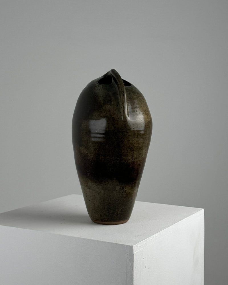 Dark green glazed stoneware vase with organic curved opening