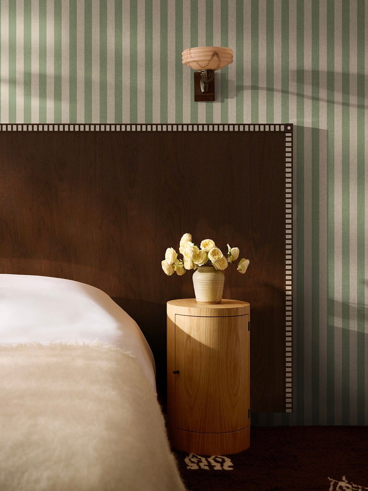 Aquarama Headboard in Chocolate Ash — side view against striped wallpaper