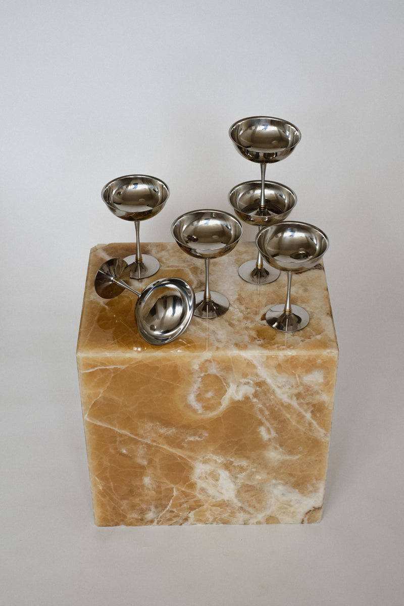 Set of 6 Large Ice Coupes — close-up on polished stainless steel on marble base