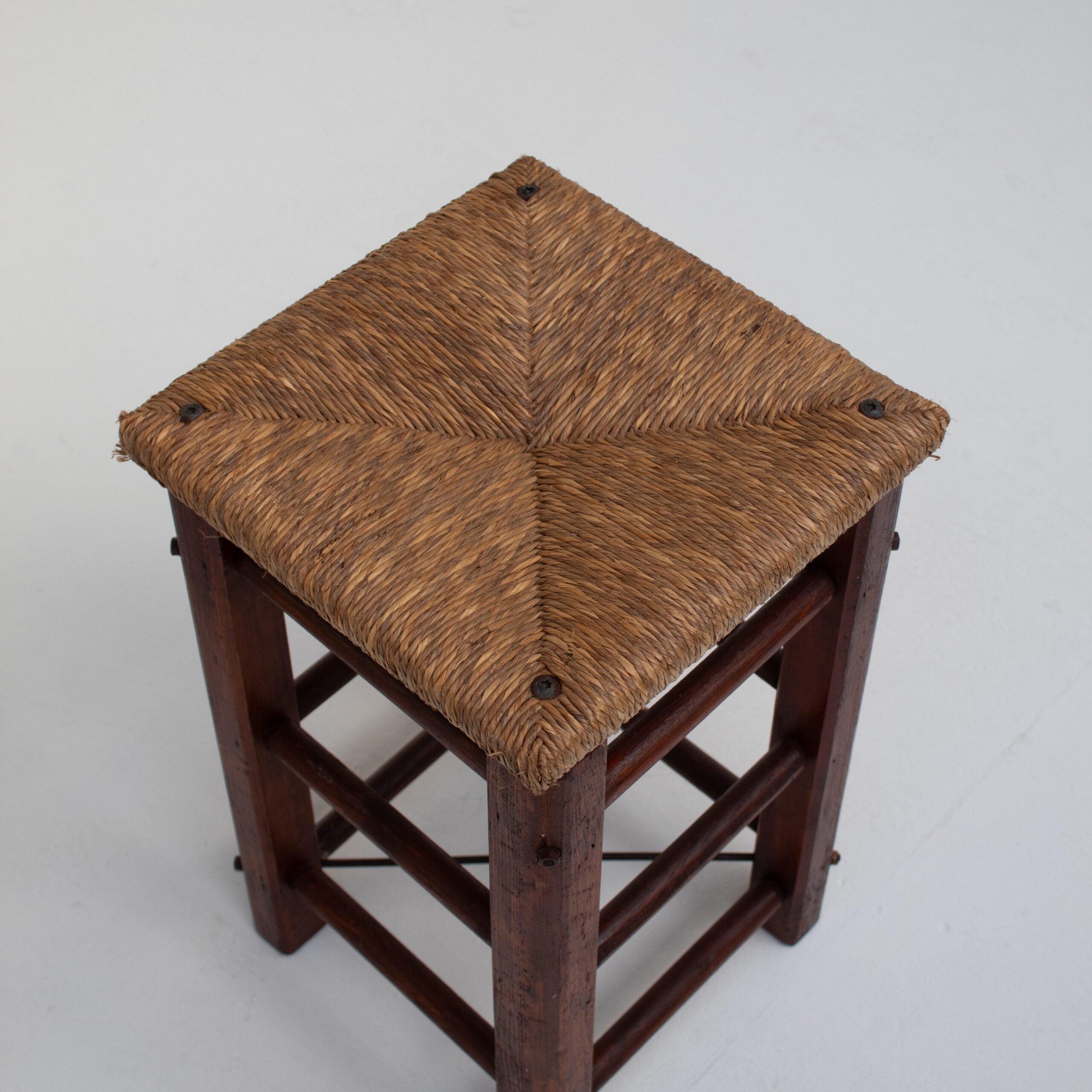 Pair of Rustic Wooden Stools with Woven Rush Seats — top view of woven rush seat
