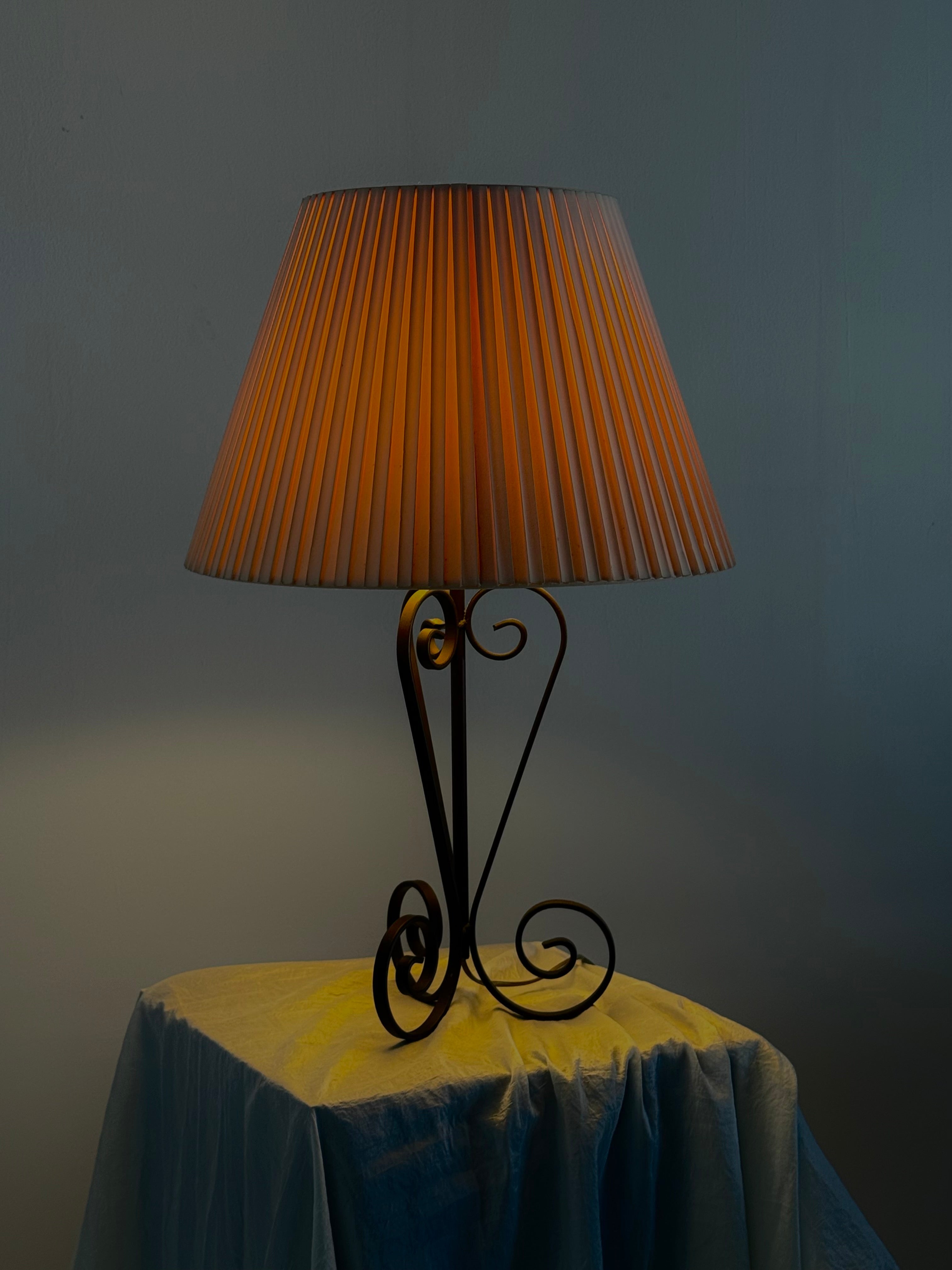 Vintage wrought iron table lamp in a swirl shape with a pleated shade by Wintage | The Oblist