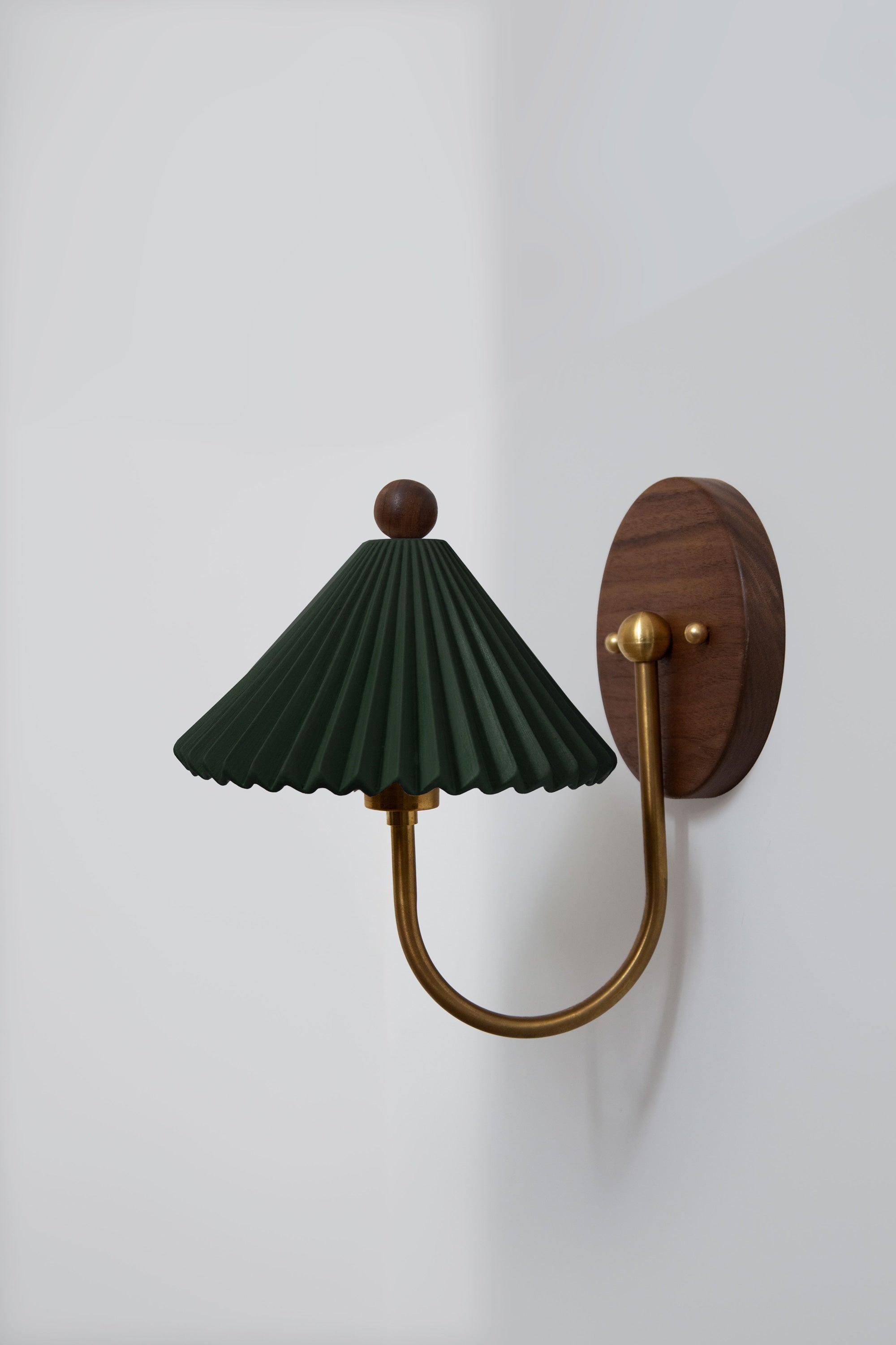 Prairie sconce with pleated green shade and brass arm wall light