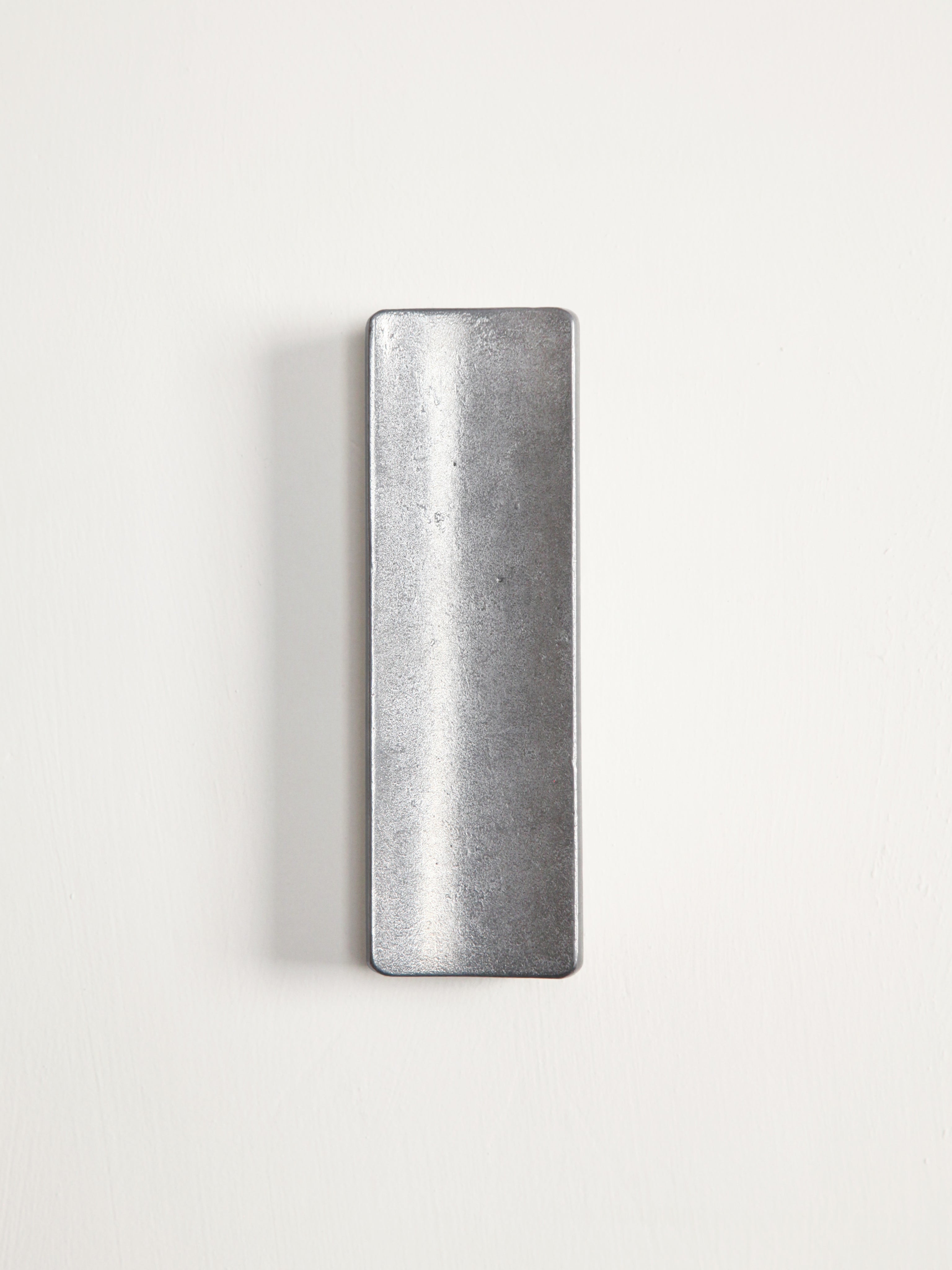 Arc Pen Tray — top view of brushed metal surface