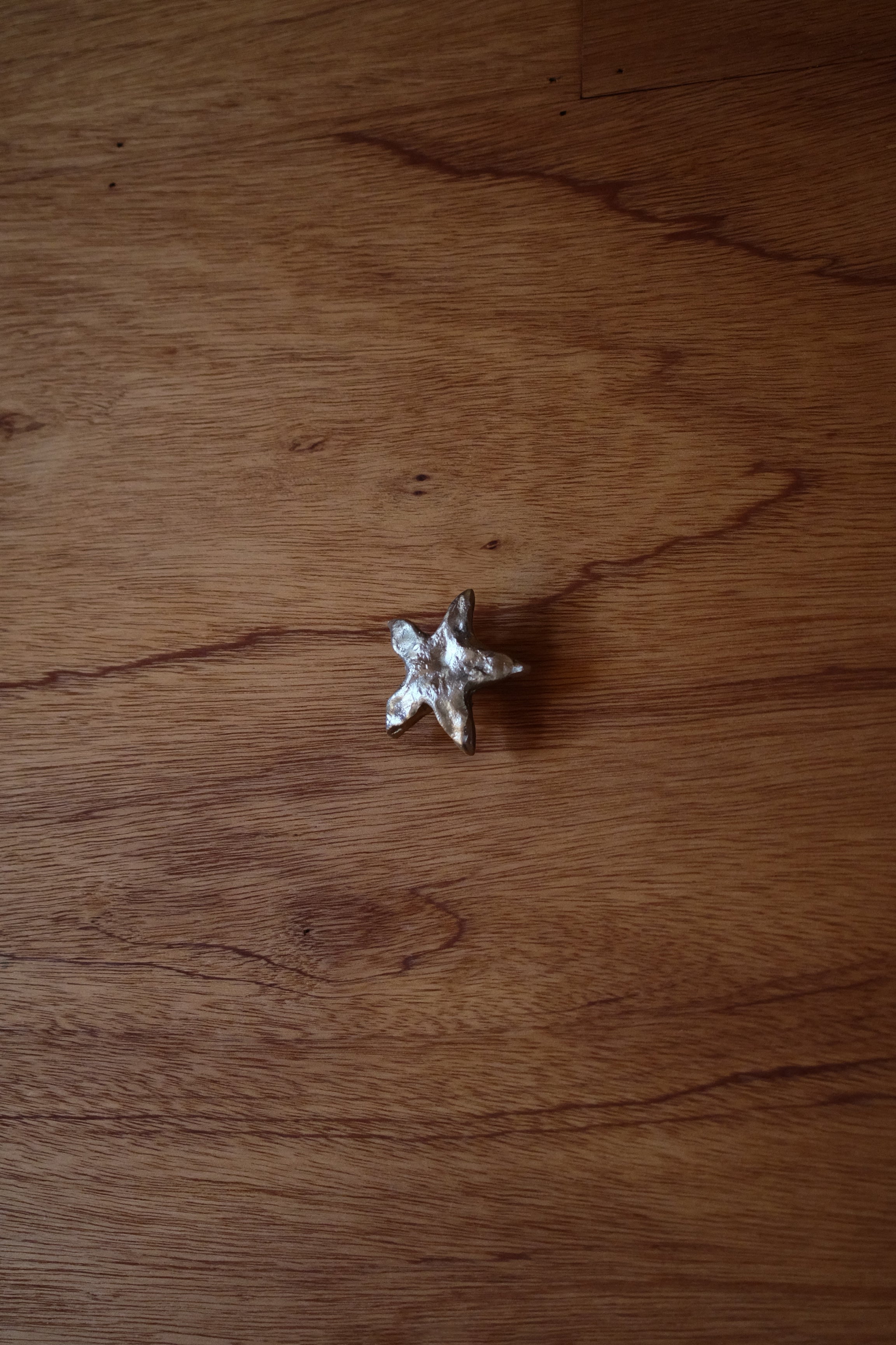 STAR Cabinet Knob/Wall Hook — top view on wooden surface