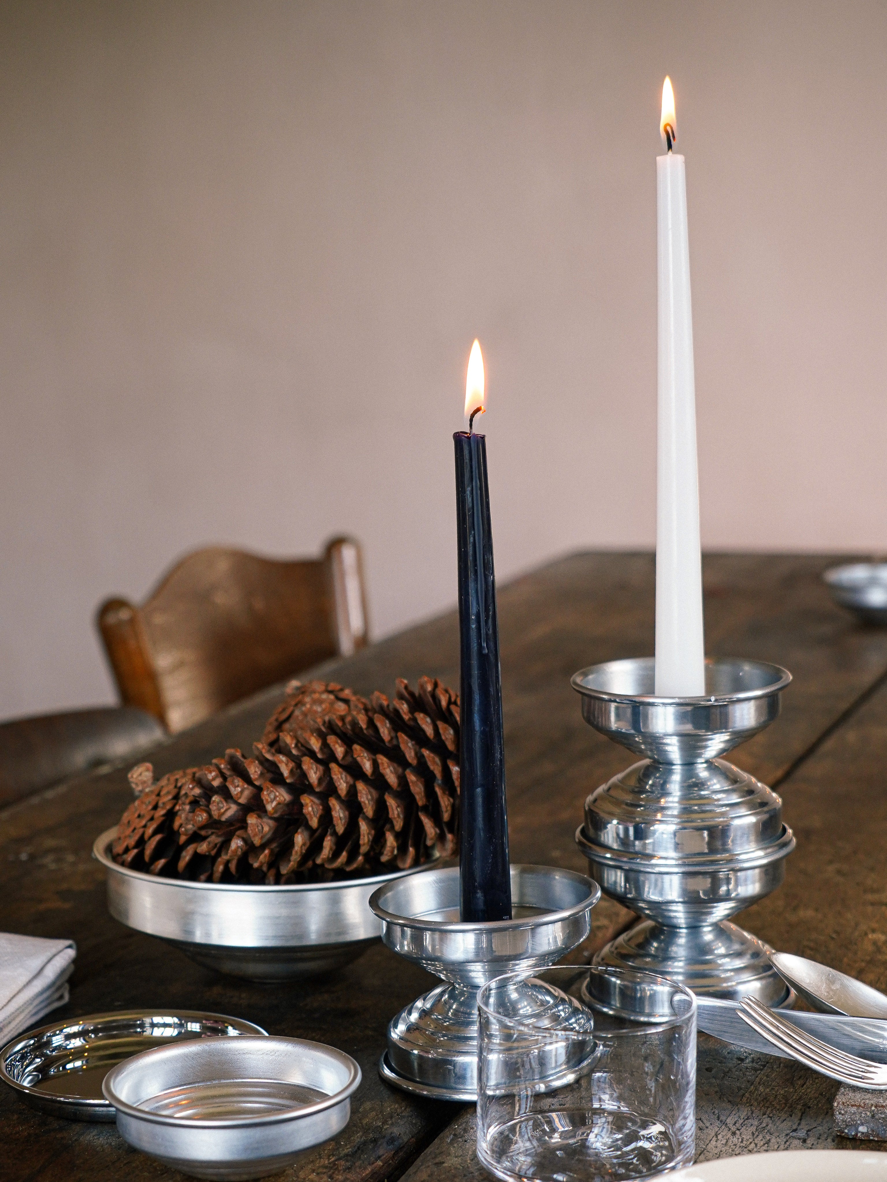 Metal Candle Holders in Polished Aluminum — top view with candles on wooden table