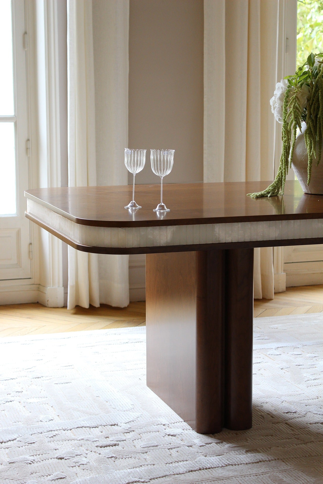 Doppio Wood And White Onyx Dining Table — close-up of wooden surface with glassware