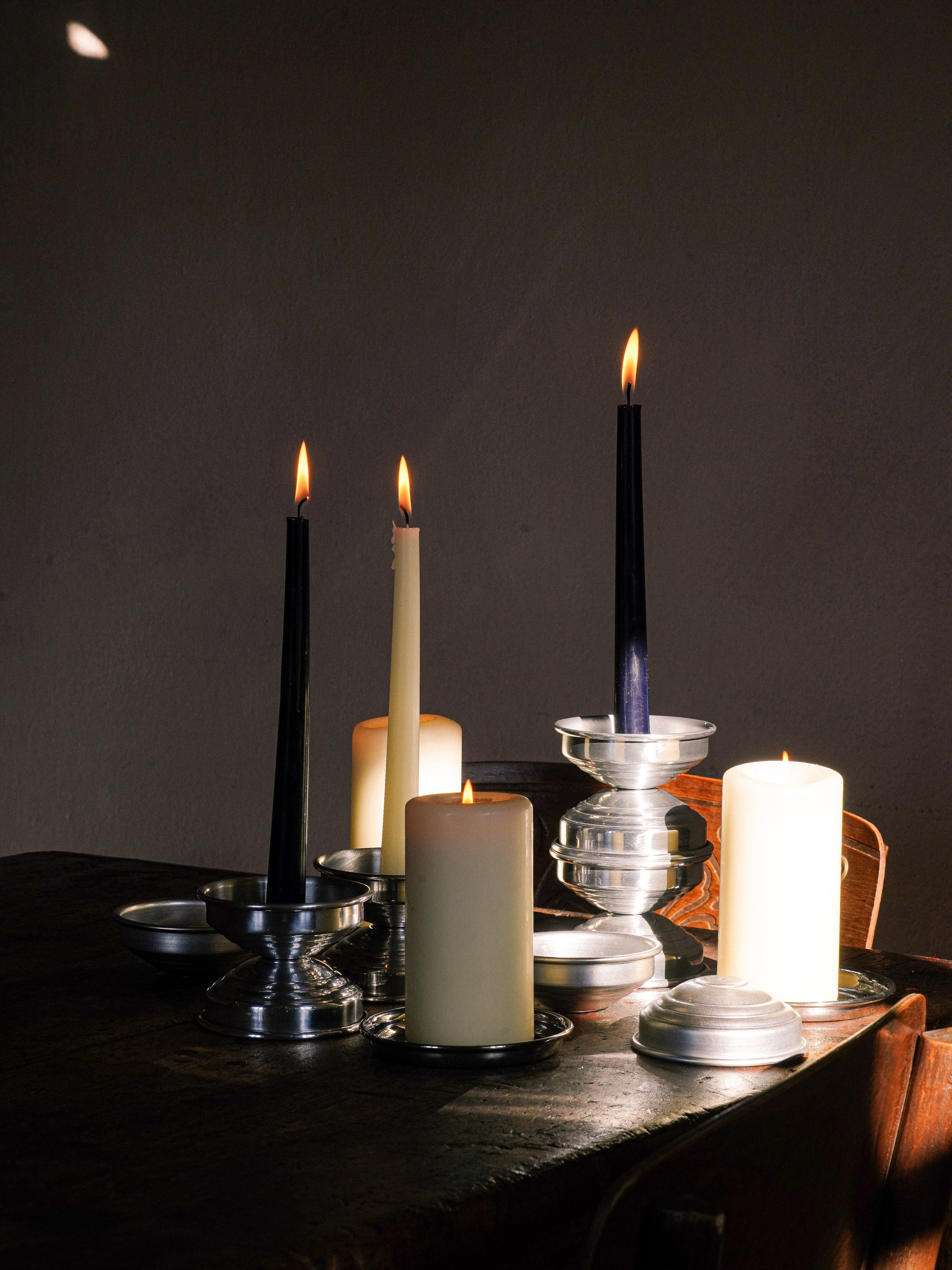 Metal Candle Holders in Polished Aluminum — back view on wooden table