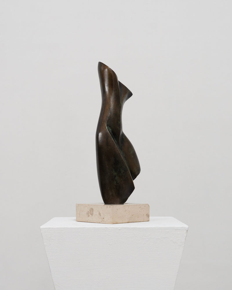 Abstract bronze sculpture with curved flowing forms on stone base