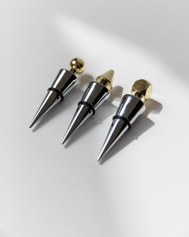 Three chrome metal bottle stoppers with gold accents from Italy 1980s
