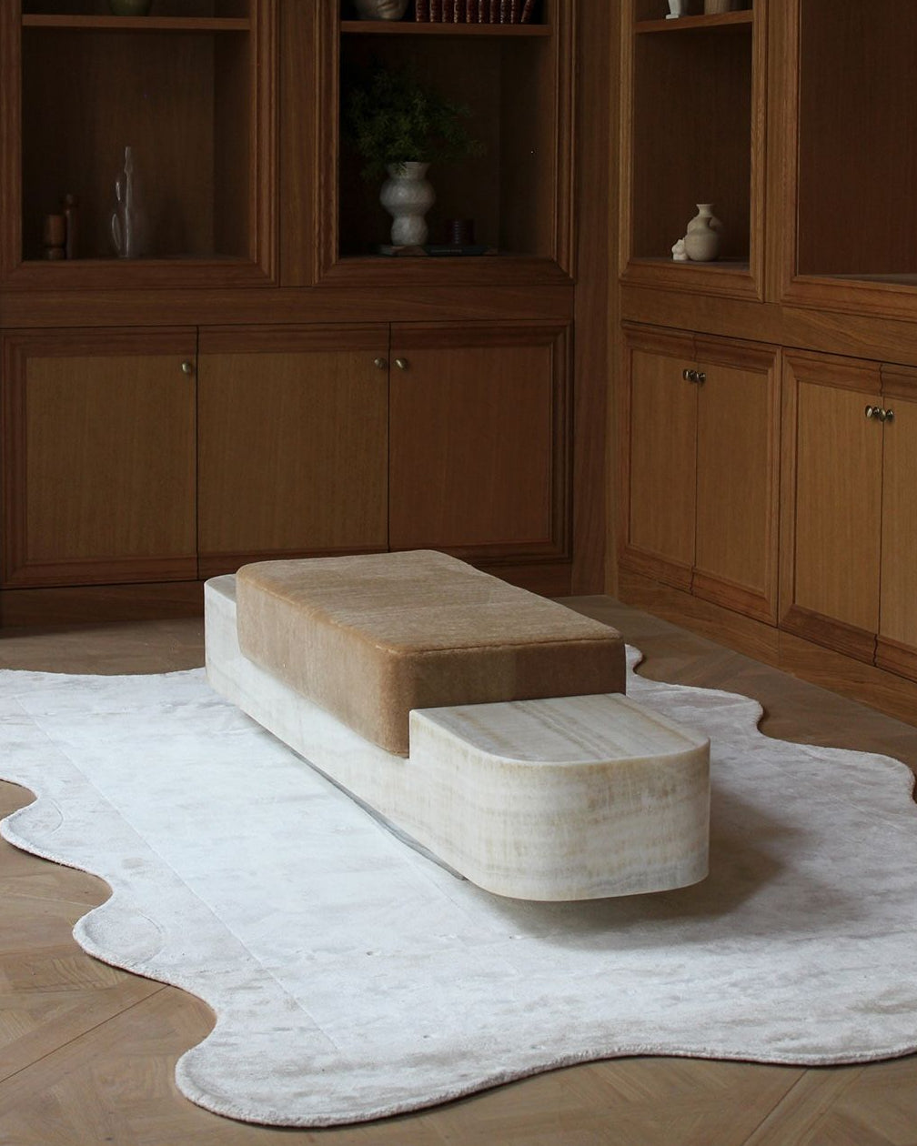 Ran Ivory Onyx Bench — side angle on plush rug in modern setting