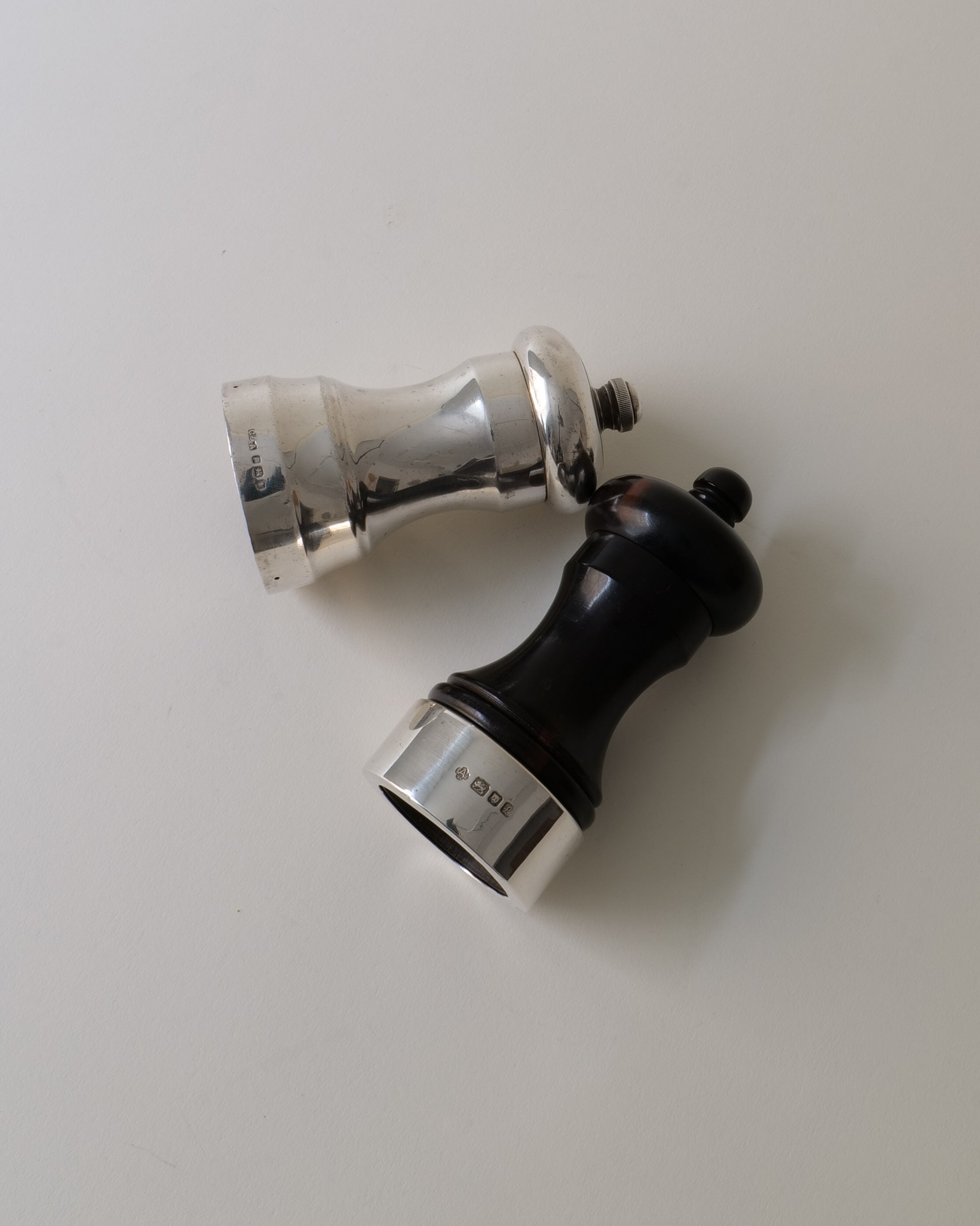 Silver and black English salt pepper grinders detail view