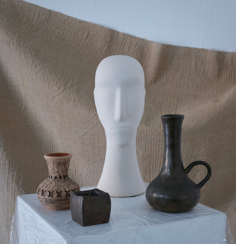 Brutalist Cast Bronze Candle Holder & Vase Set, 1970s — close-up of bronze vase on textured surface