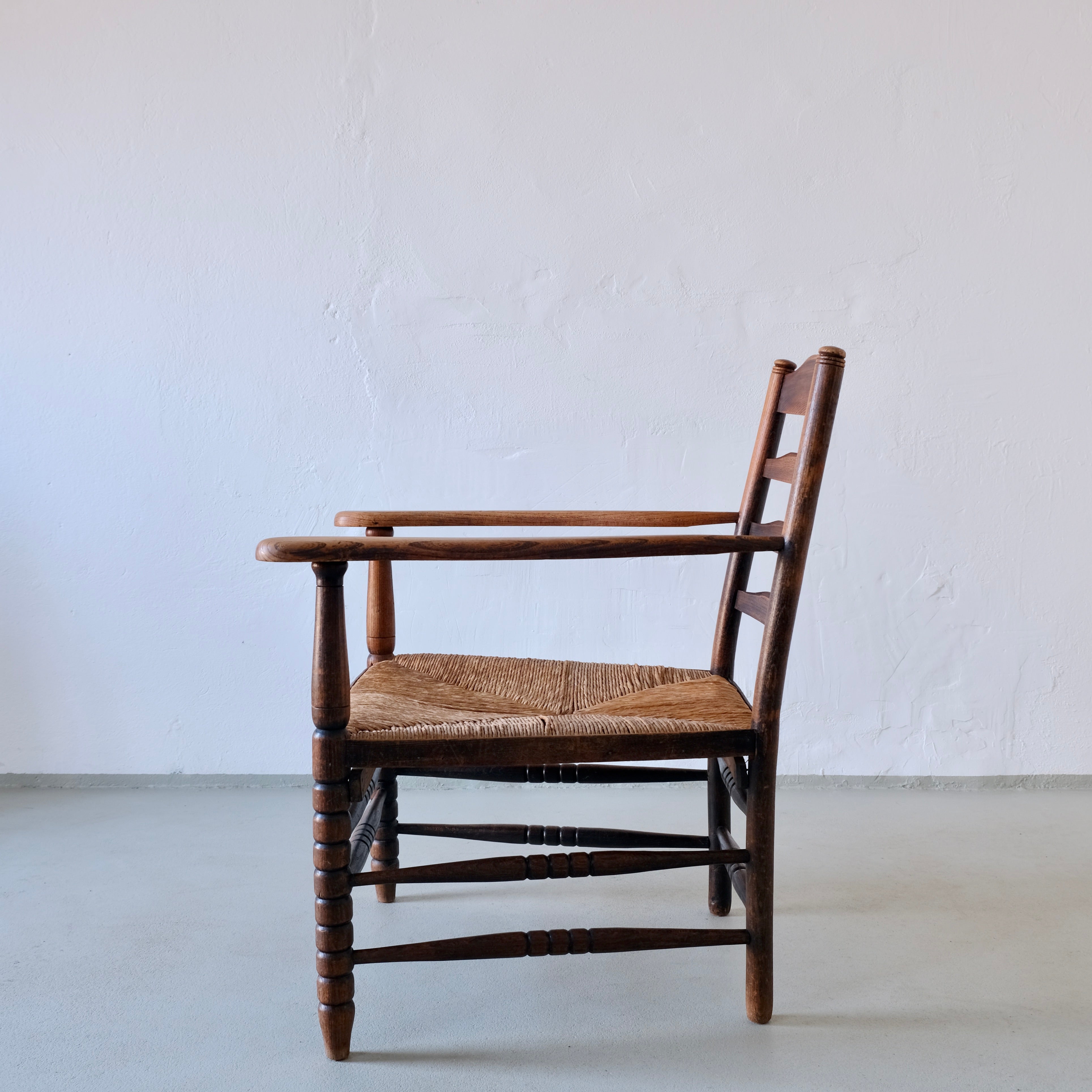 Rustic Bobbin Rush Seat Low Armchair | Netherlands | 1940s — lifestyle setting