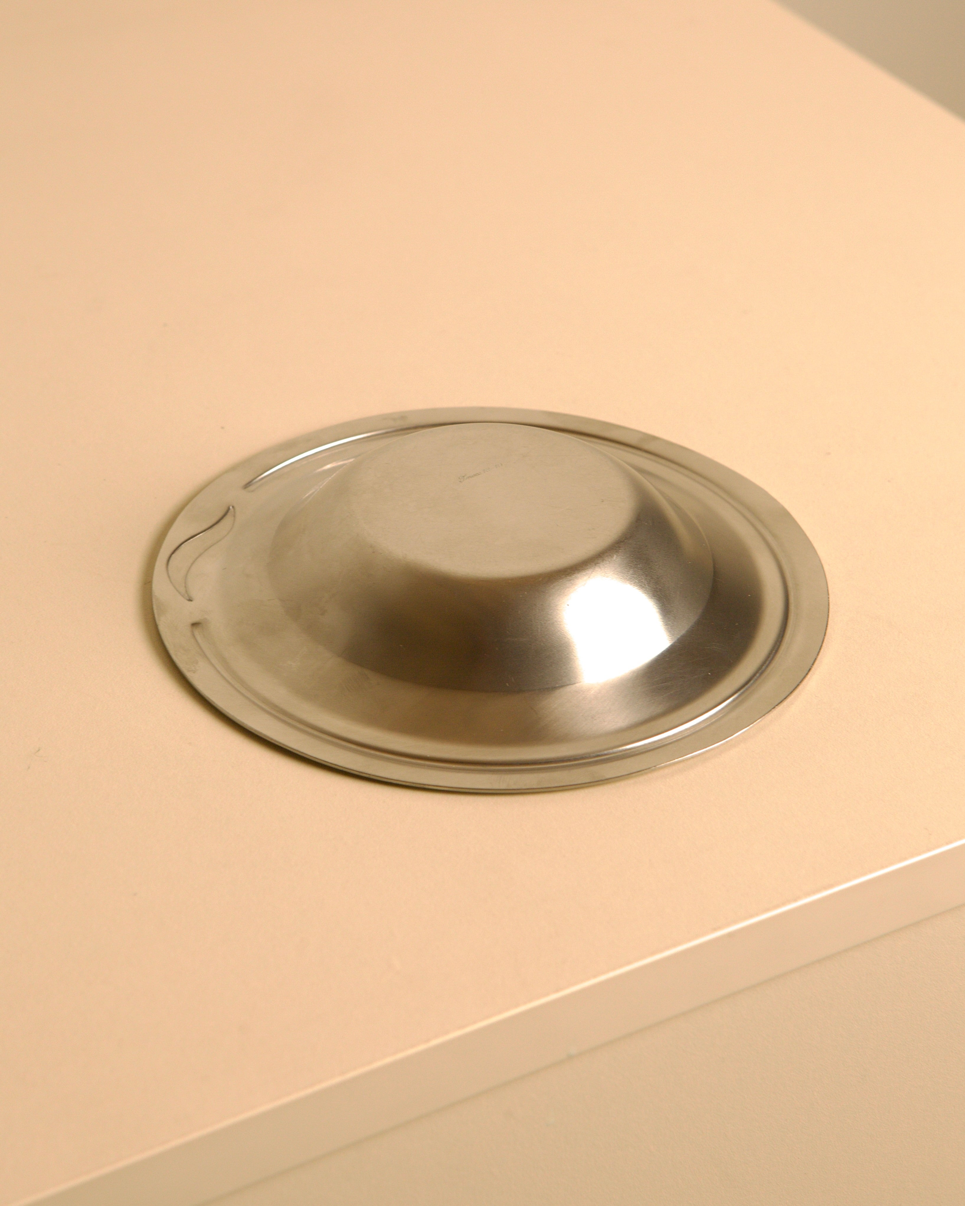 Circular stainless steel valet tray by Pierre Cardin, 1980s — top view on neutral surface