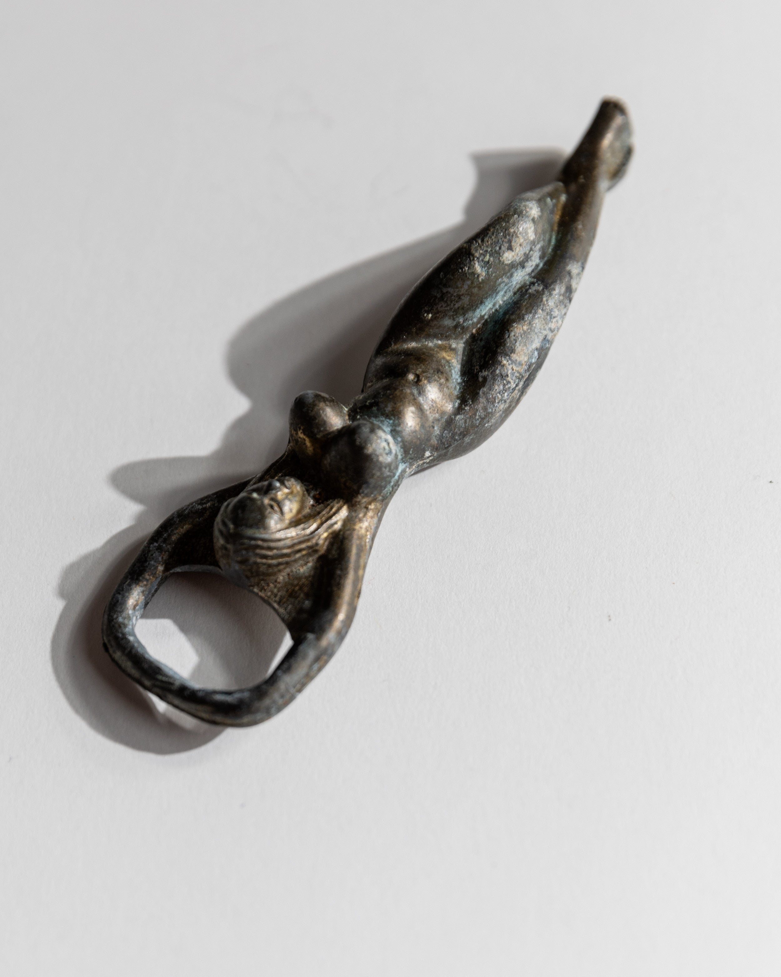 Vintage 1940s Bottle Opener Brass, Nude Woman Shape — angled view on white background