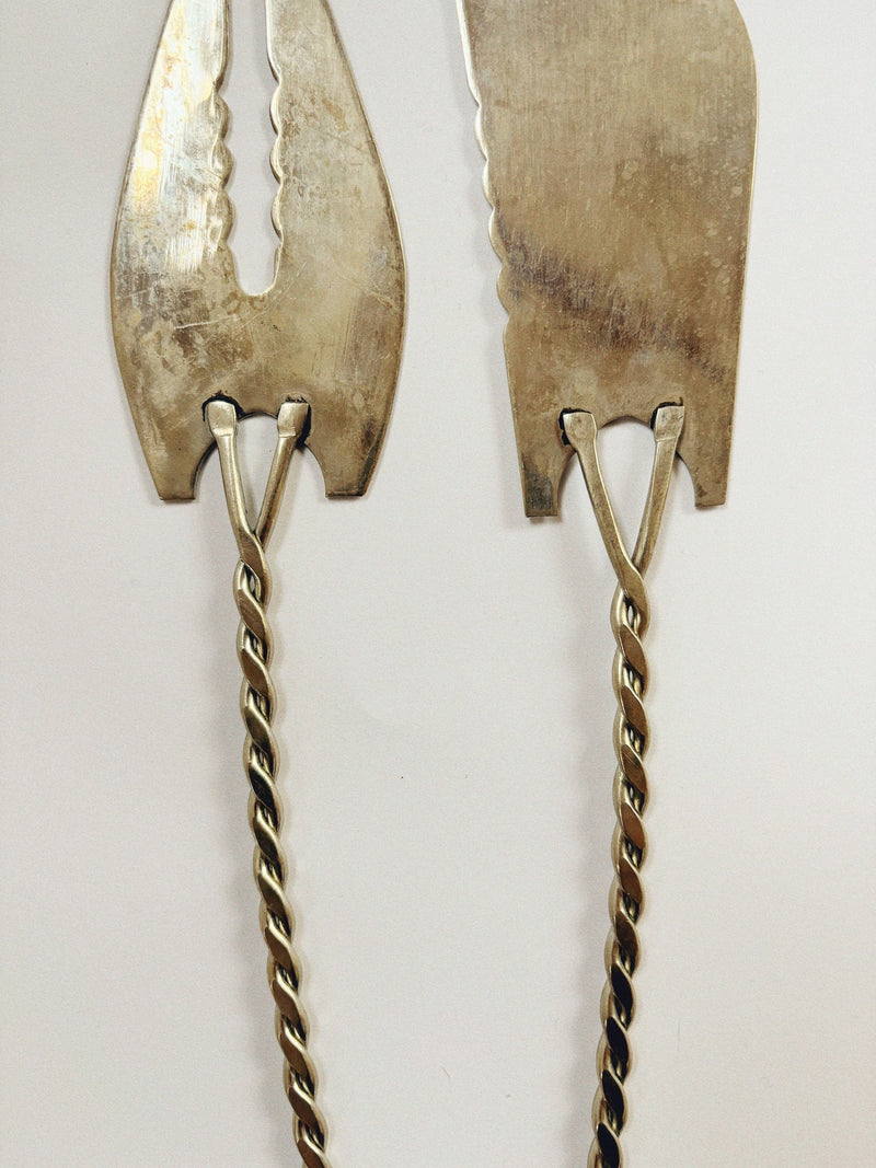 The Huerto Silver Plated Filigree Serving Cutlery features vintage metal ice tongs with detailed twisted handles and flat, serrated gripping ends, displayed on a plain white background.