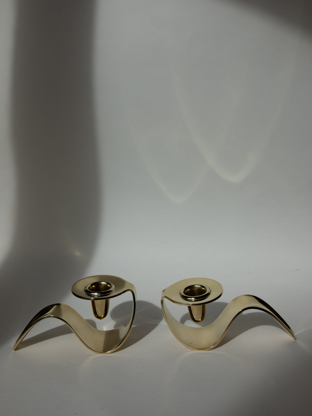 Rare Brass Candle Holders by Carl M. Cohr, Denmark, c. 1960s — angled view on neutral background