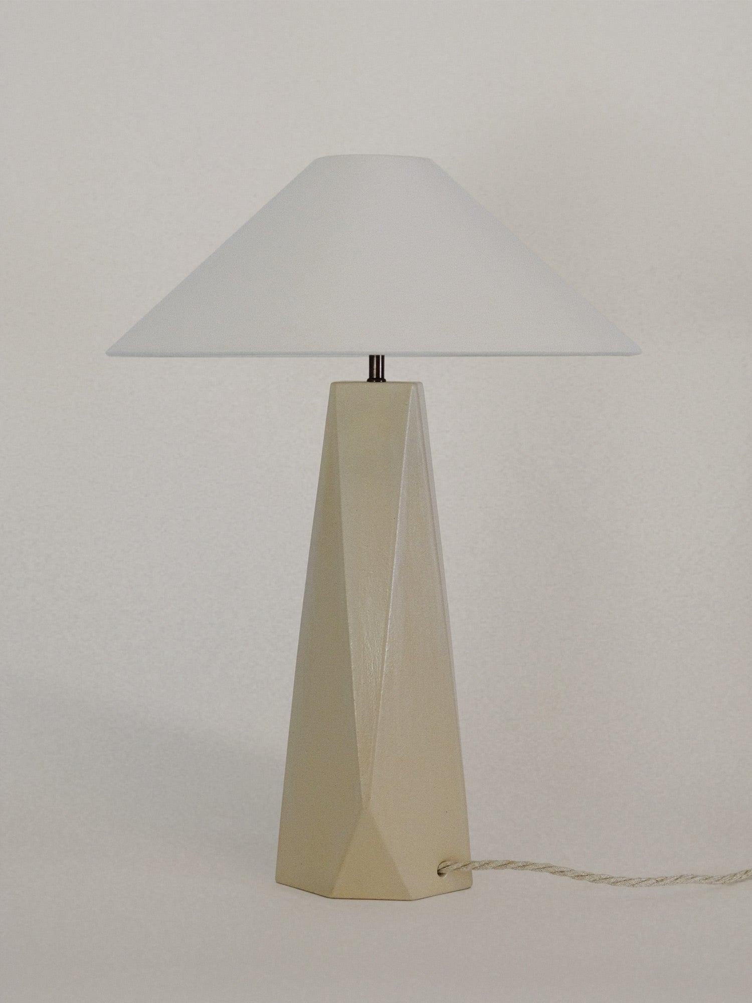 Off white geometric table lamp with conical shade and angular ceramic base