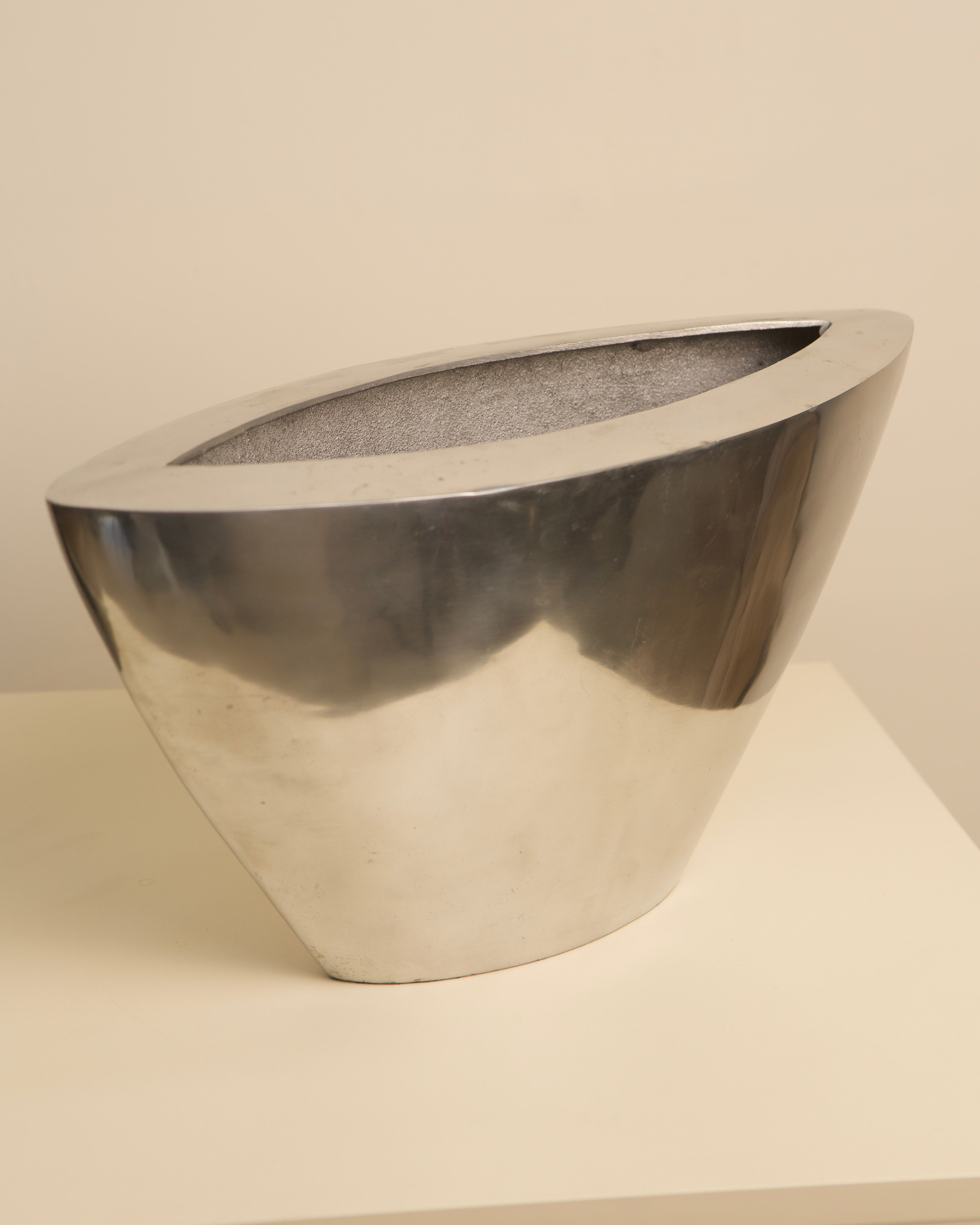 Polished metal vase with curved asymmetrical silhouette, 1980s Italian design