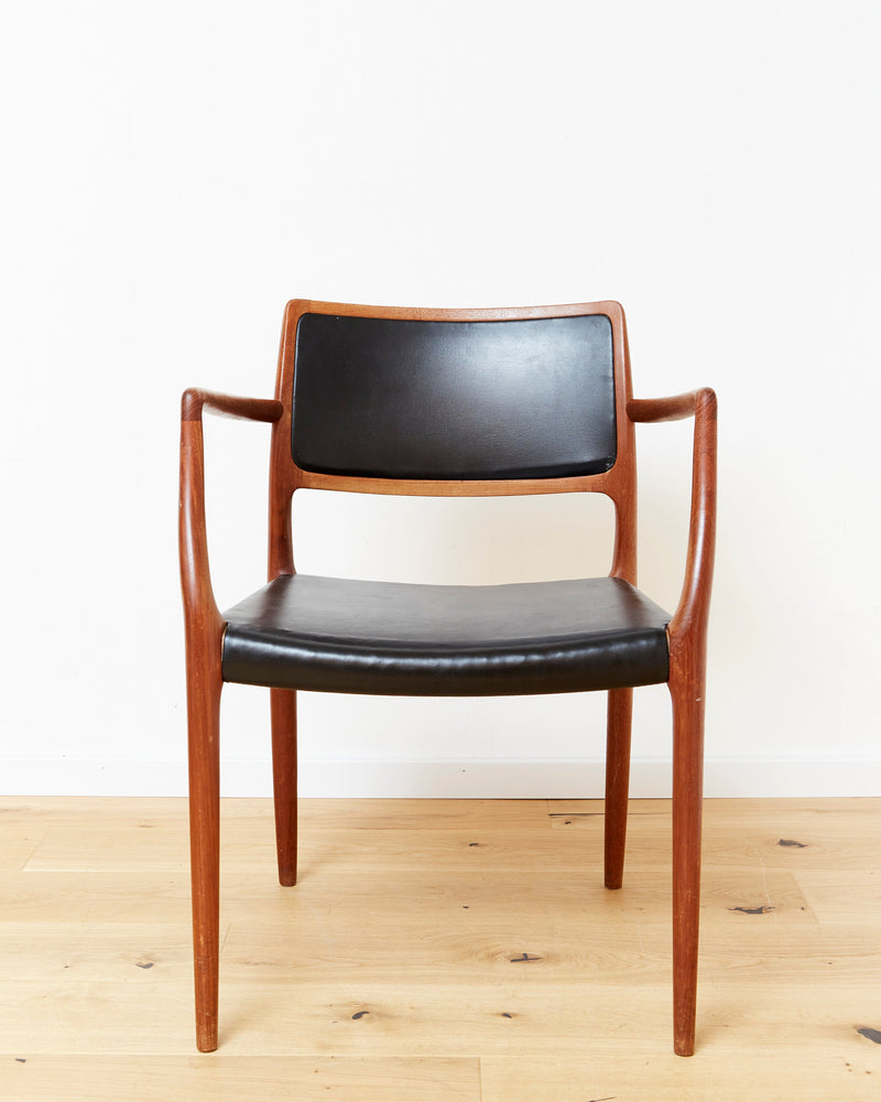 Niels Otto Møller teak armchair No.65 with black leather upholstery