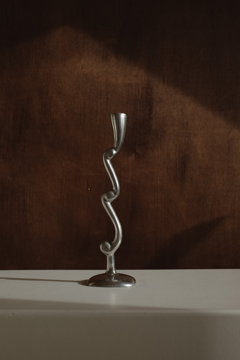 Curly Candle Holder — close-up of twisted metal design on white surface